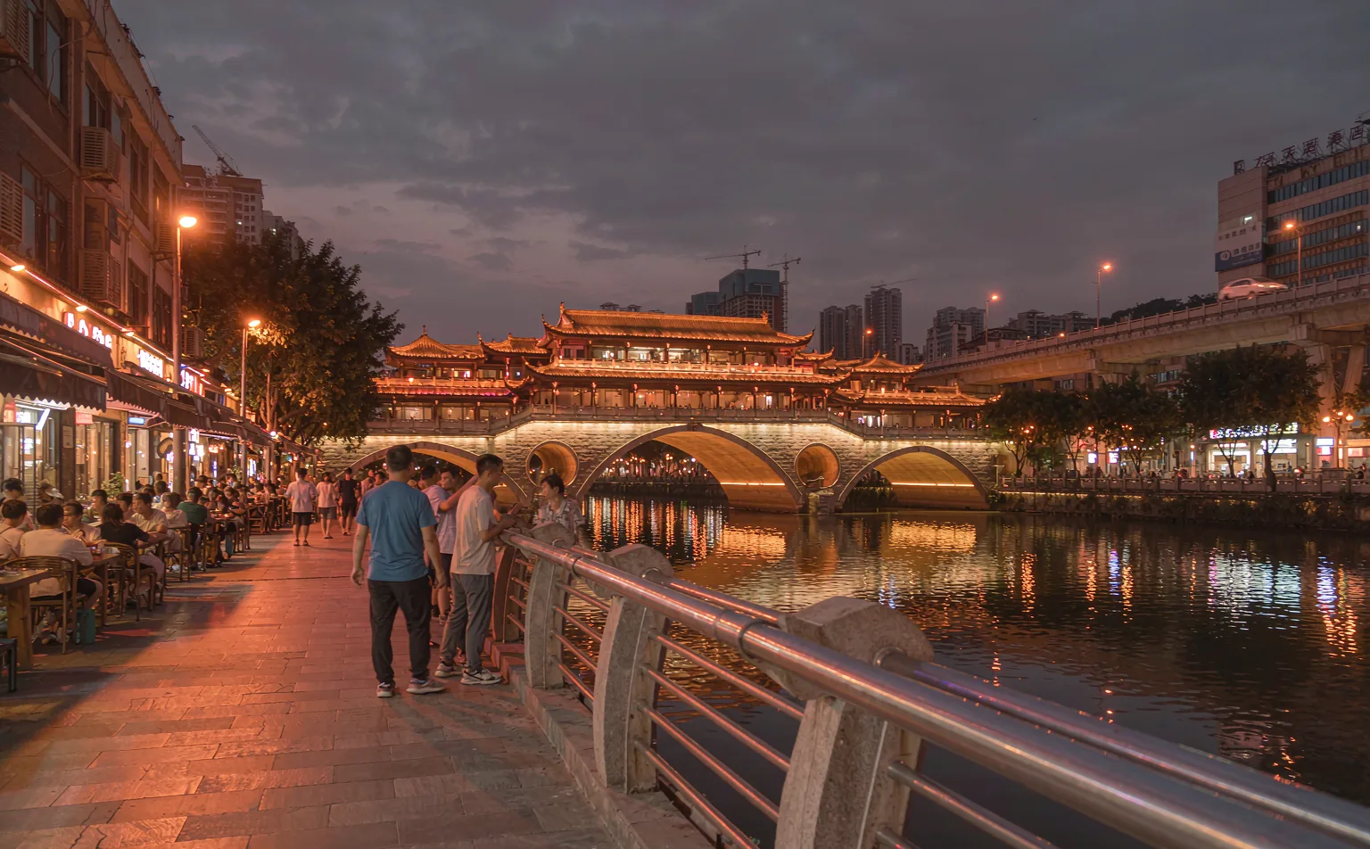 Evening riverside walkway approaching Anshun Bridge in Chengdu