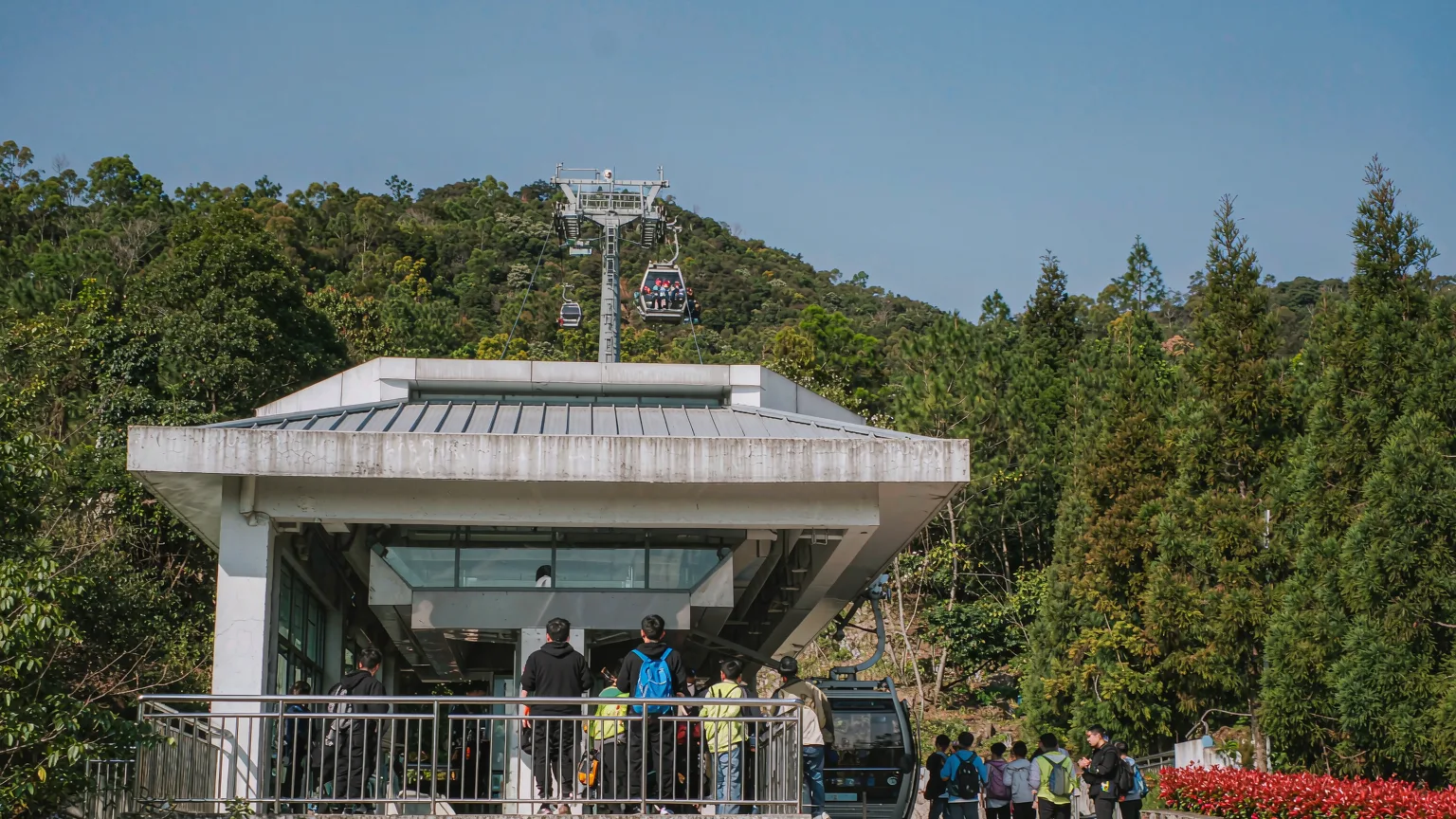 Tourists boarding cable car at Baiyun Mountain base station