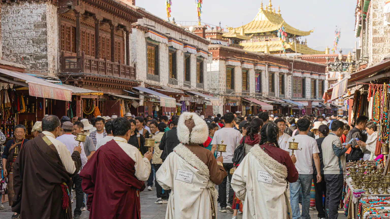 Pilgrims and merchants on Barkhor Street with Jokhang Temple behind