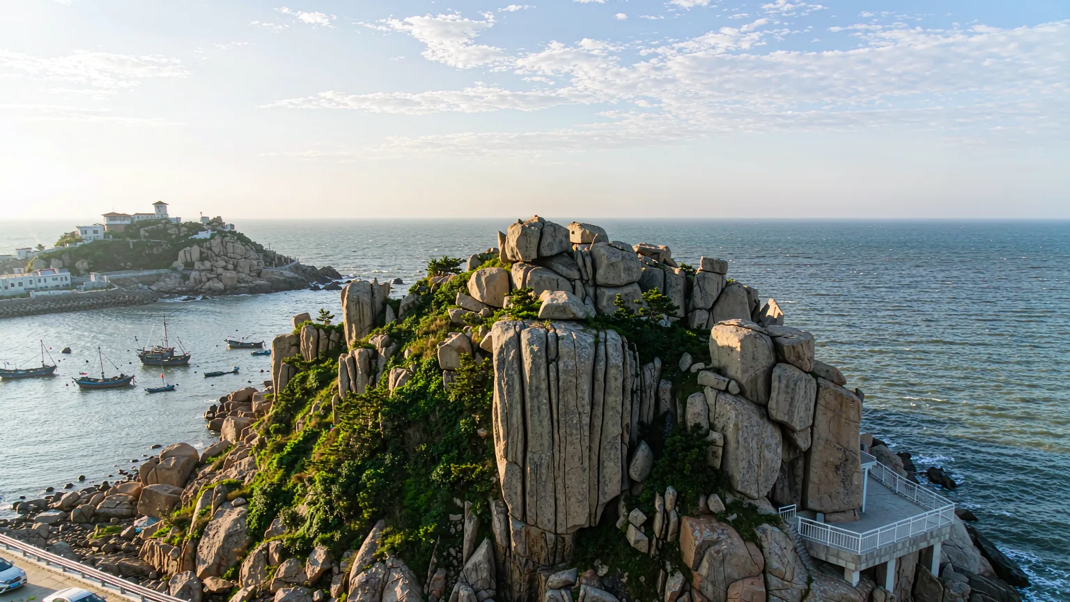 Binhai Road winding along granite cliffs above a fishing cove in Dalian
