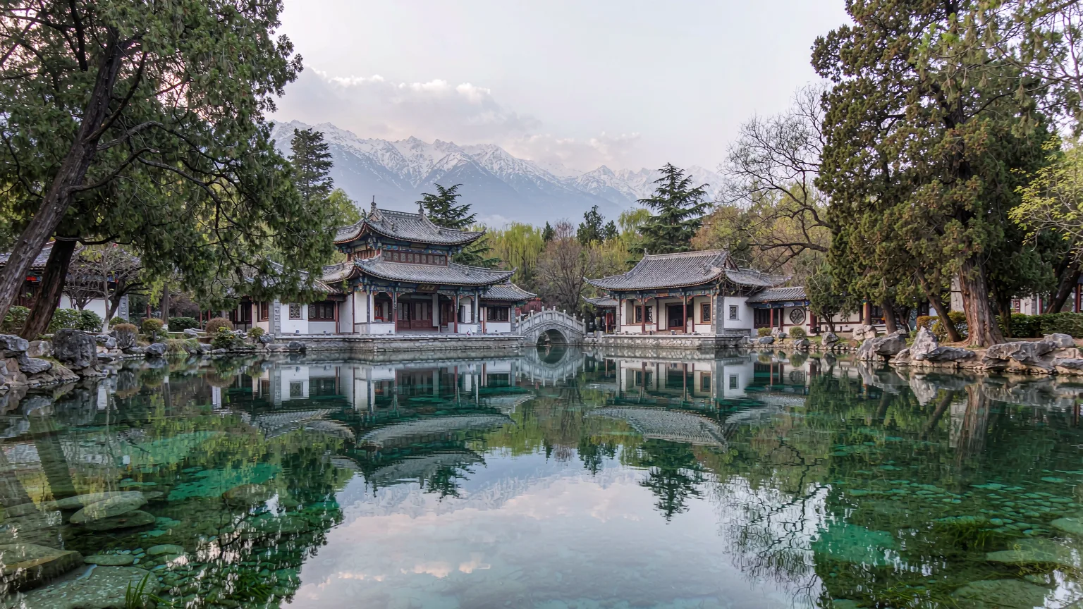 Black Dragon Pool Park with pavilions and mountain reflection in clear water