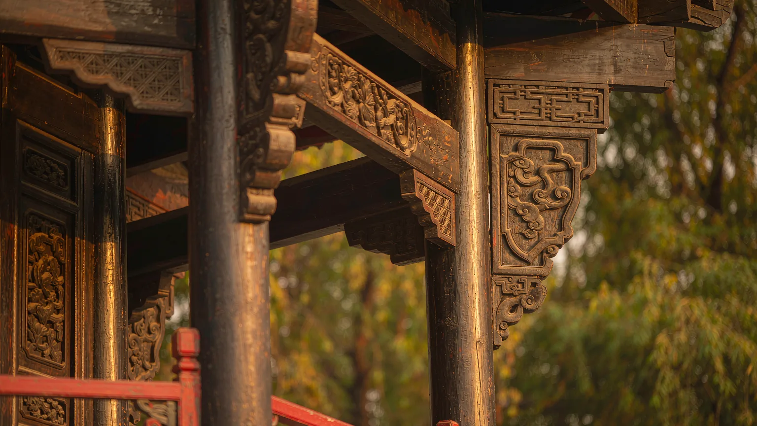 Close-up of intricate wooden carvings on a pavilion in Black Dragon Pool Park