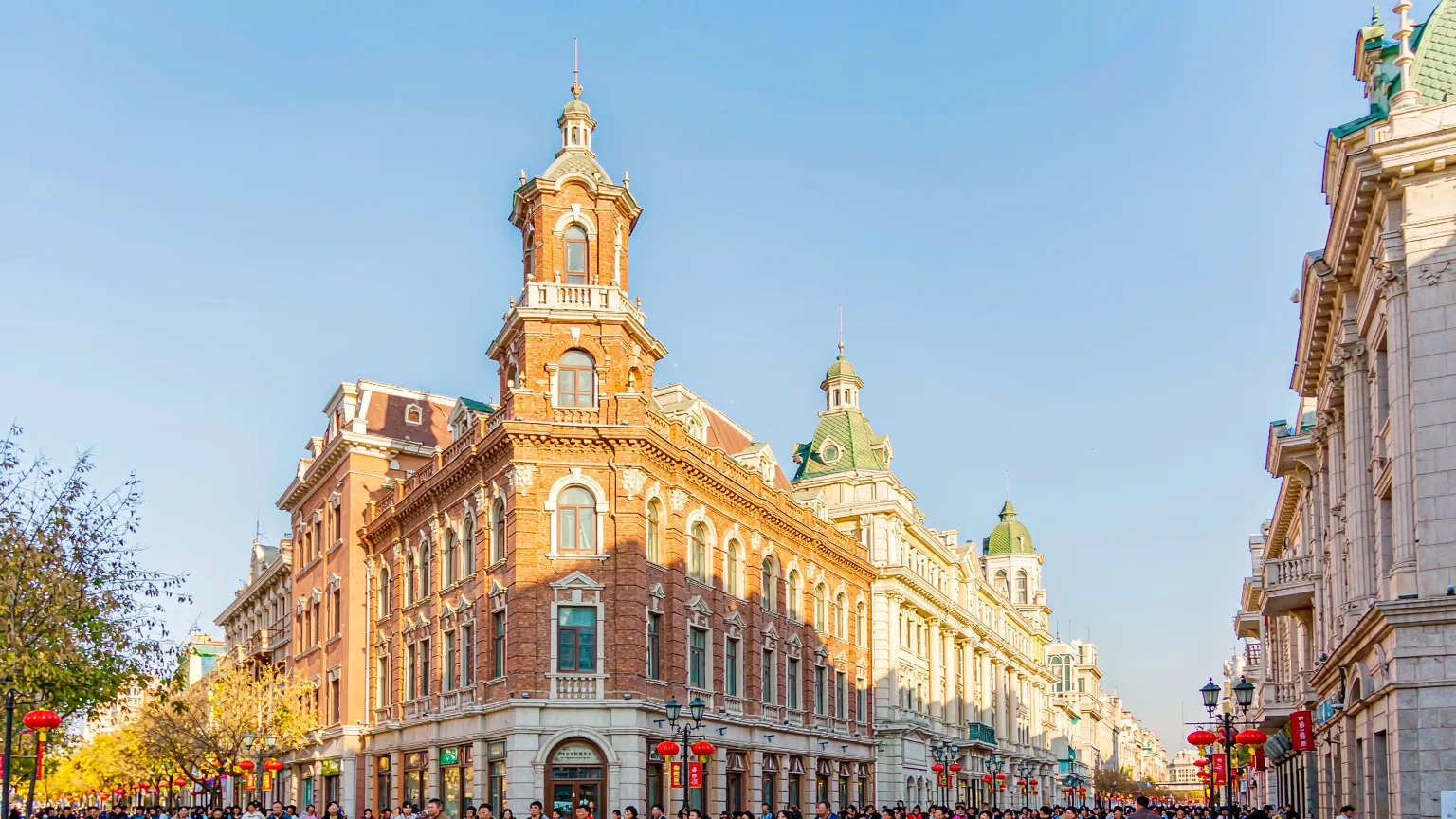 Bustling daytime scene on Central Street Harbin with European architecture