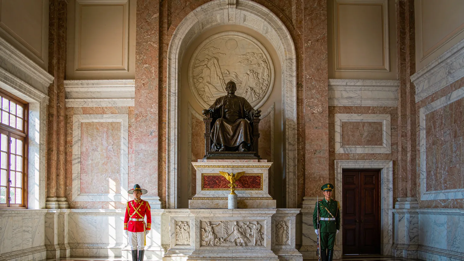 Bronze statue of Chiang Kai-shek seated on throne inside memorial hall