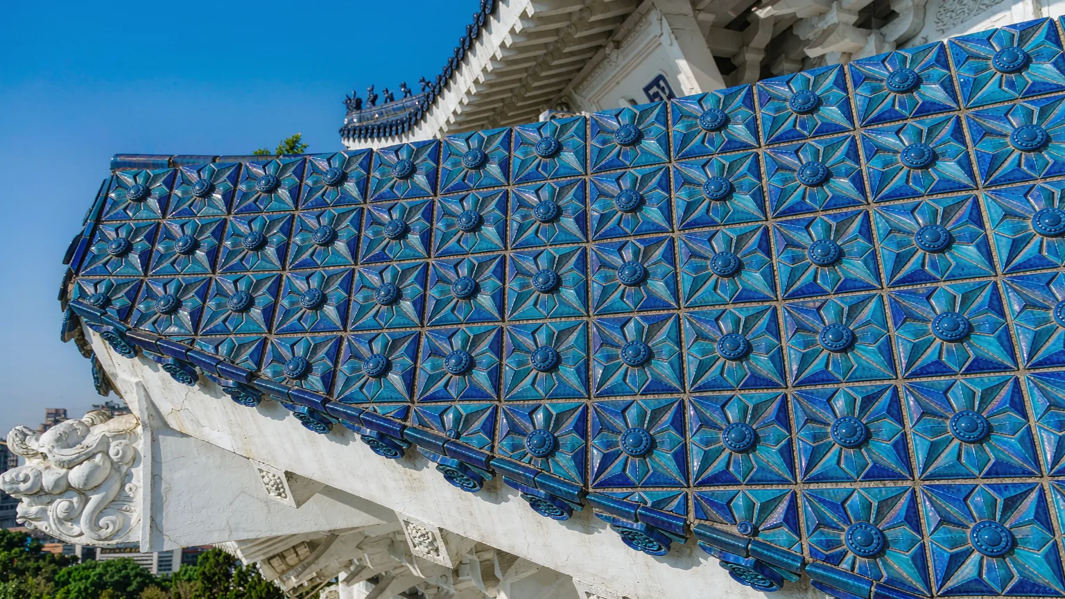 Close-up of blue roof tiles and white marble details of memorial hall