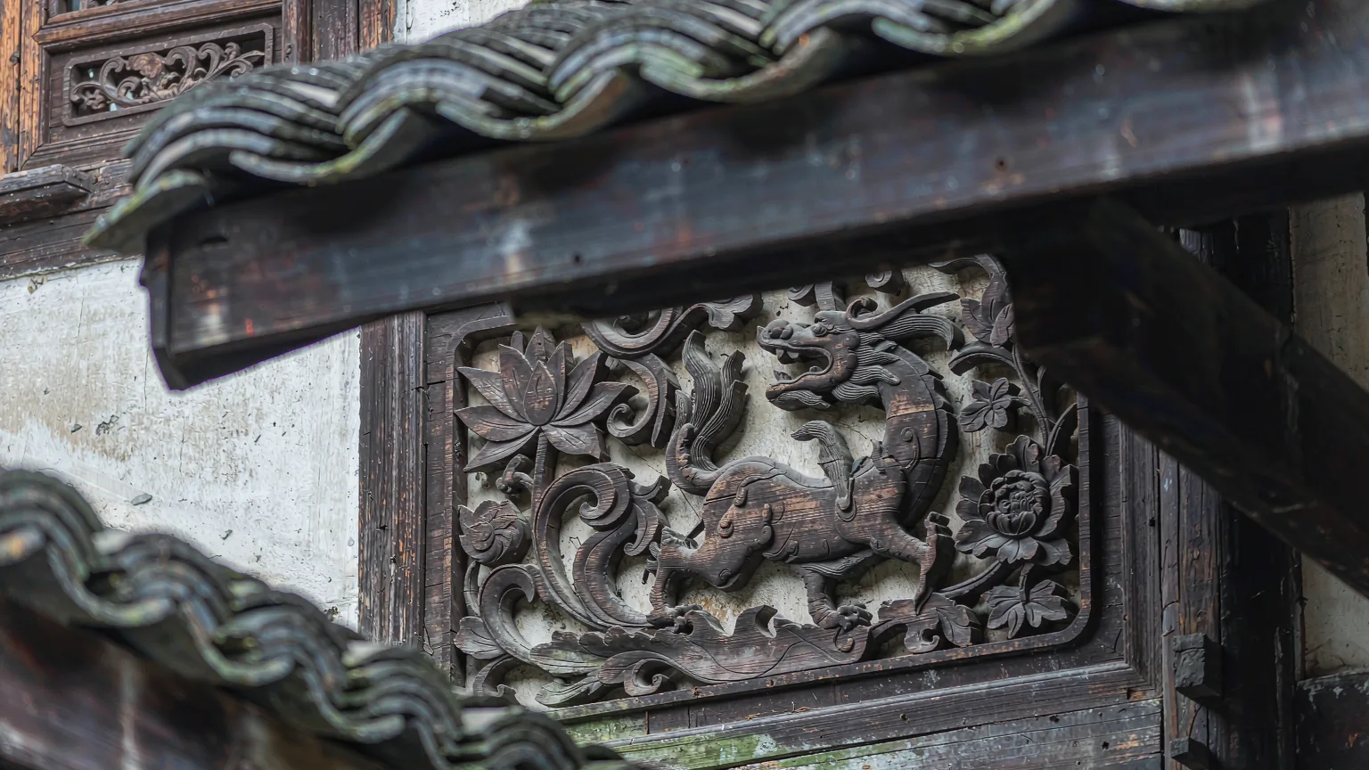 Detailed wood carvings on a historic building in Ciqikou Ancient Town