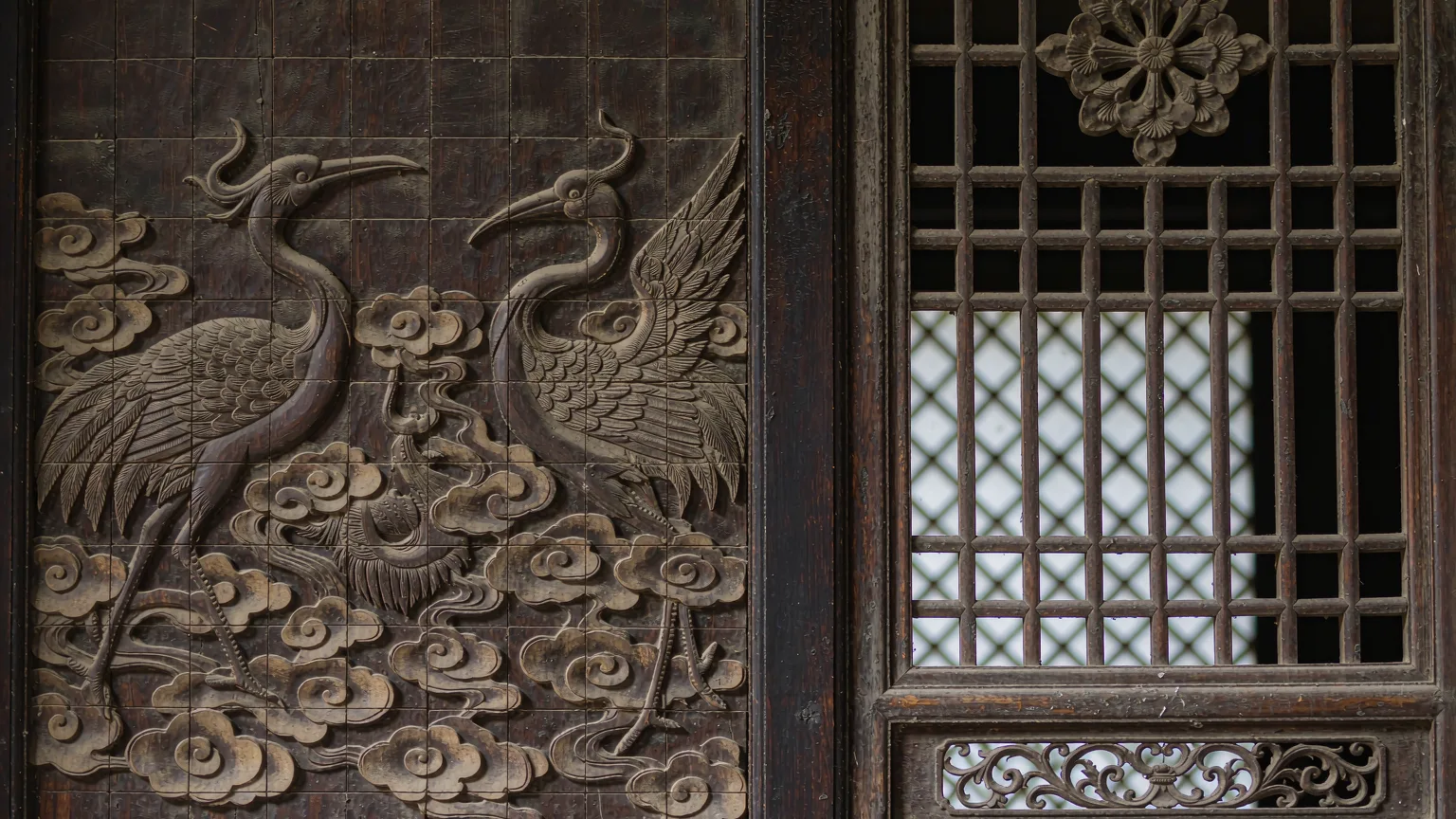 Detailed wood carvings on a door in the Confucius Mansion, Qufu