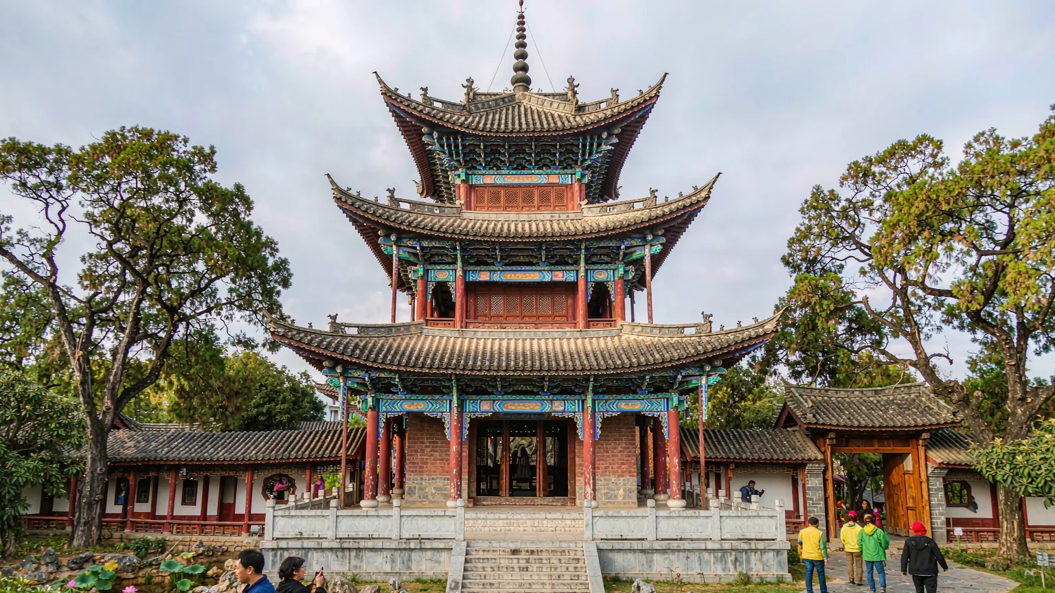 Front view of Daguan Pavilion with red pillars and garden surroundings