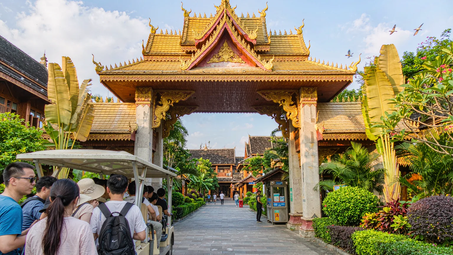 Ornate entrance gate of Dai Park with visitors arriving by shuttle