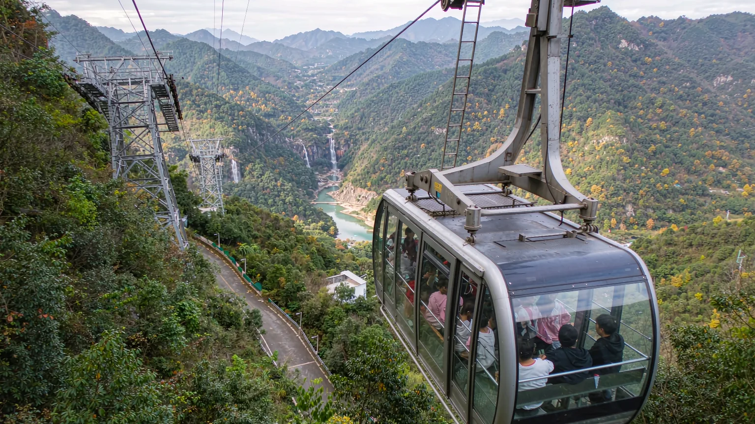 Cable car ascending Damingshan with forest and waterfall views