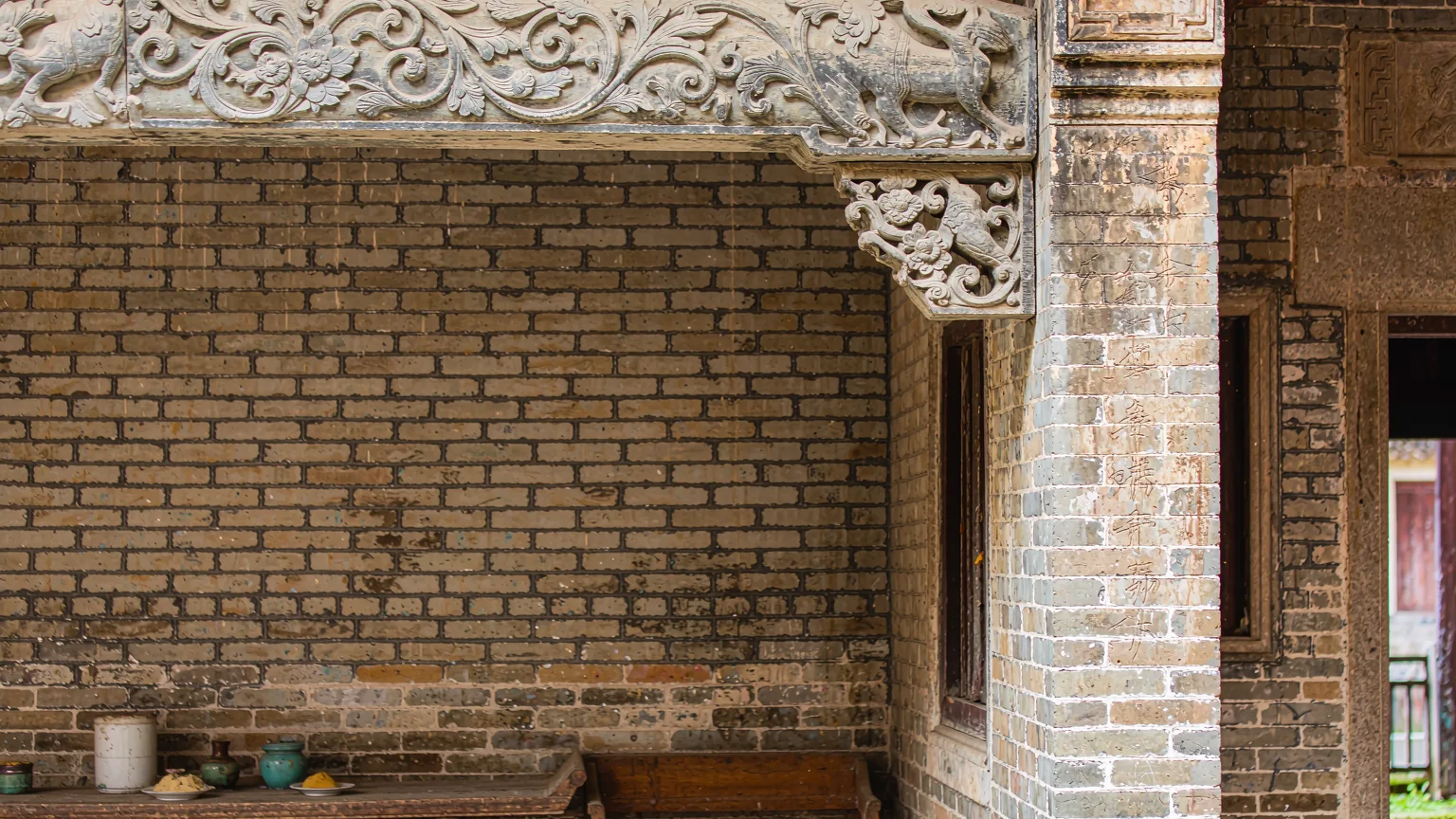 Close-up of carved stone lintel and altar in an ancestral hall at Dapeng Fortress