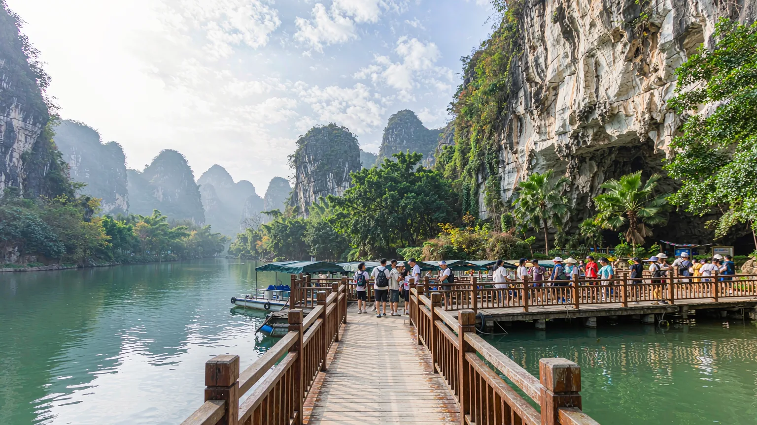 Boardwalk and boat dock at Dragon Palace entrance with tourists