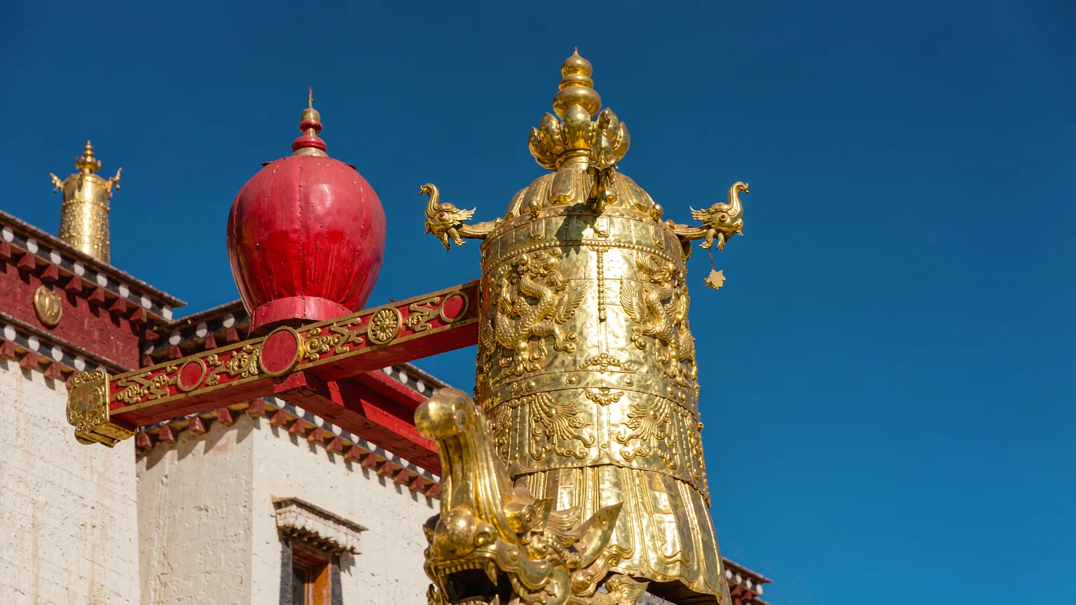Golden roof ornament with intricate carvings at Drepung Monastery chapel