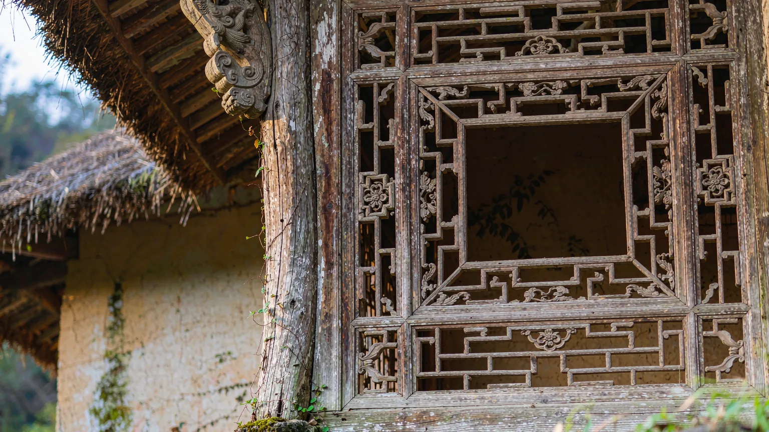 Close-up of weathered wooden pillar and lattice window at Du Fu Thatched Cottage