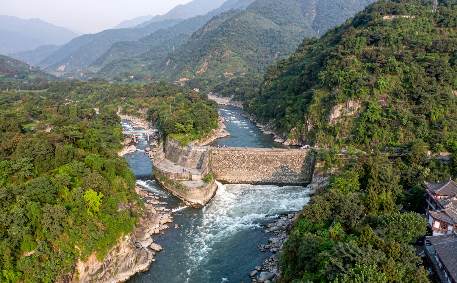 The ancient Dujiangyan irrigation channels carrying the Min River between green mountains
