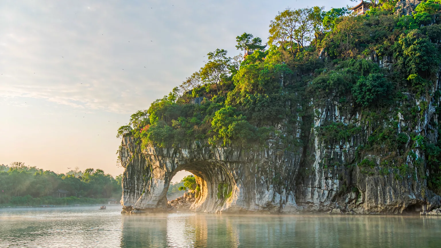 Elephant Trunk Hill karst formation with pavilions and misty river confluence