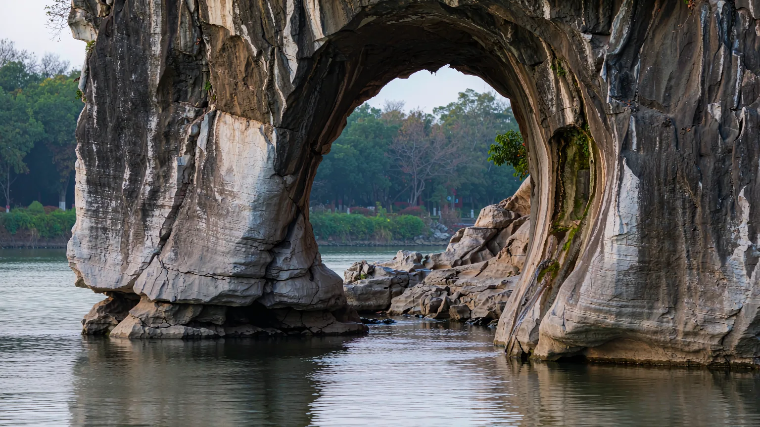 Close-up of Elephant Trunk Hill's rock arch and cave entrance by the water