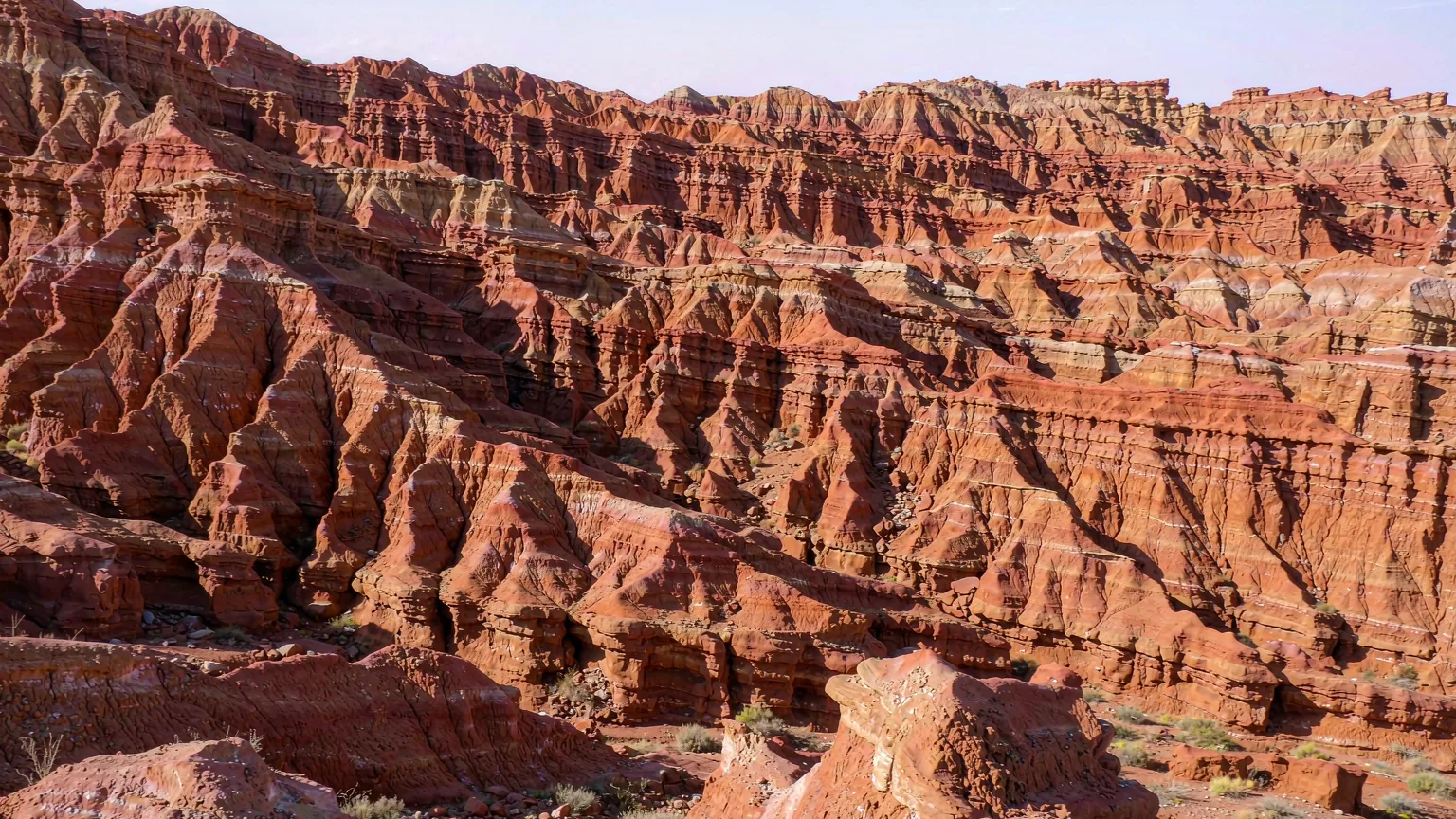 Eroded red sandstone ridges and gullies of the Flaming Mountains