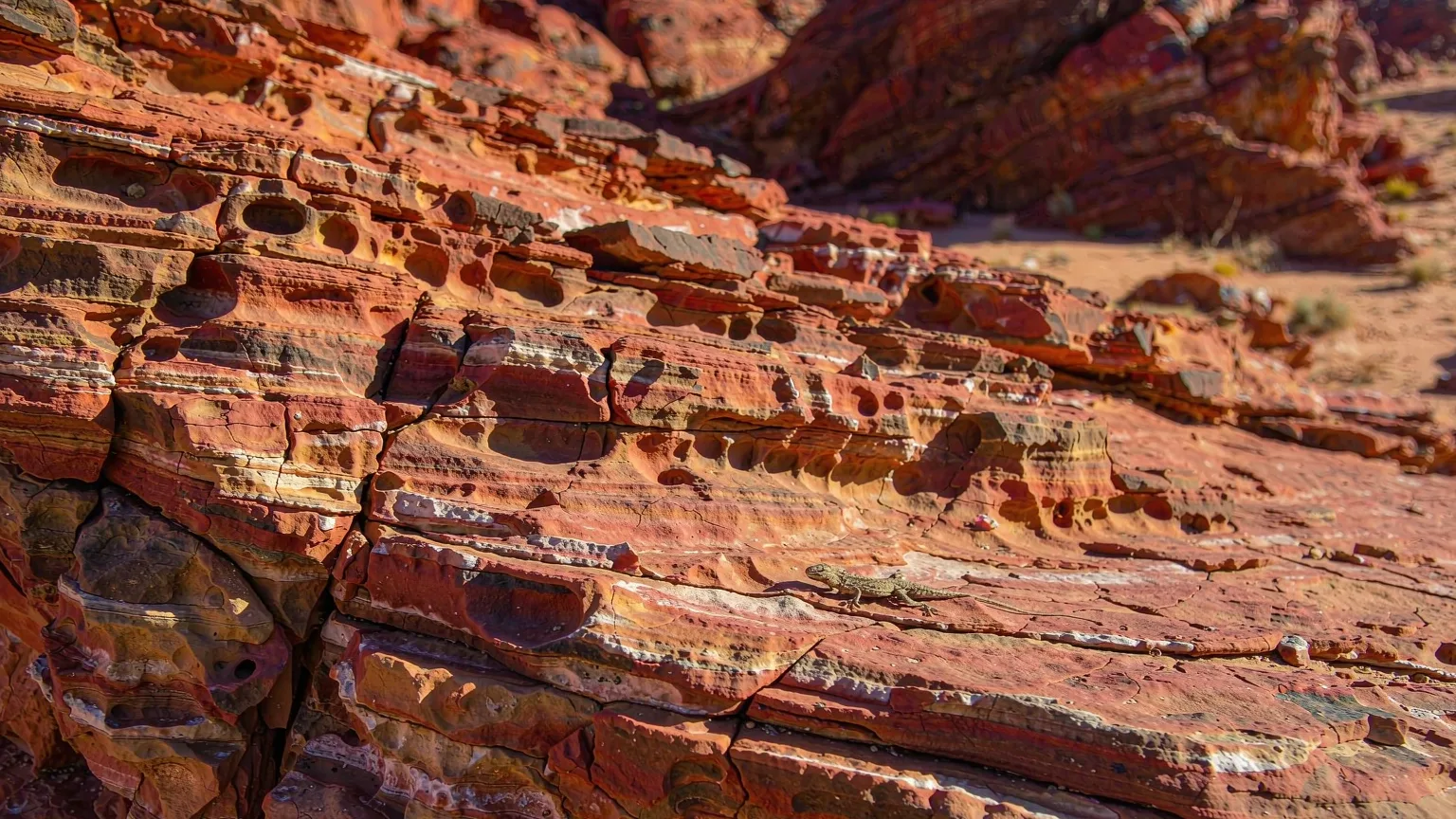 Close-up of cracked red rock layers in Flaming Mountains