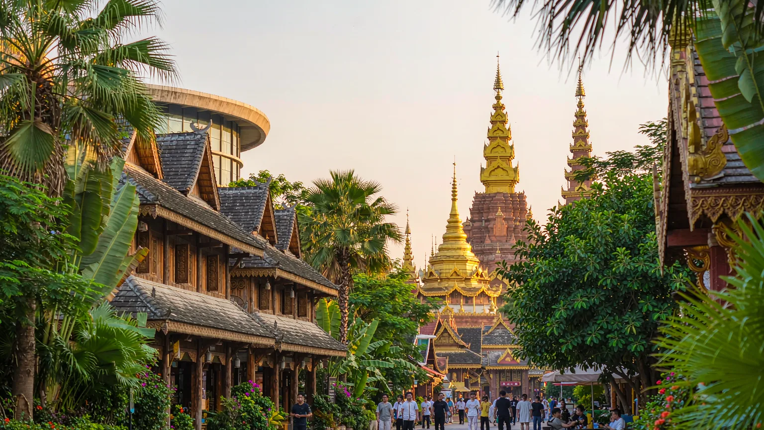 Dai stilt houses and golden temple spires in Gaozhuang Xishuangjing cultural district