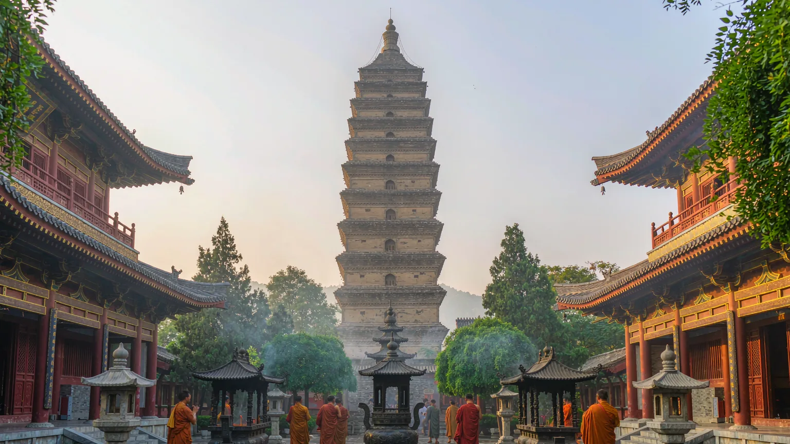 Giant Wild Goose Pagoda in temple courtyard with monks and incense