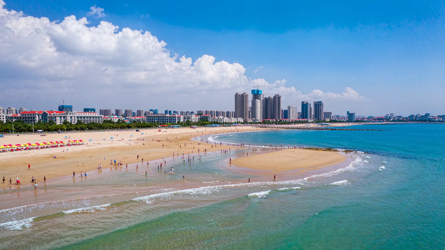 Aerial view of Golden Beach with swimmers and umbrellas