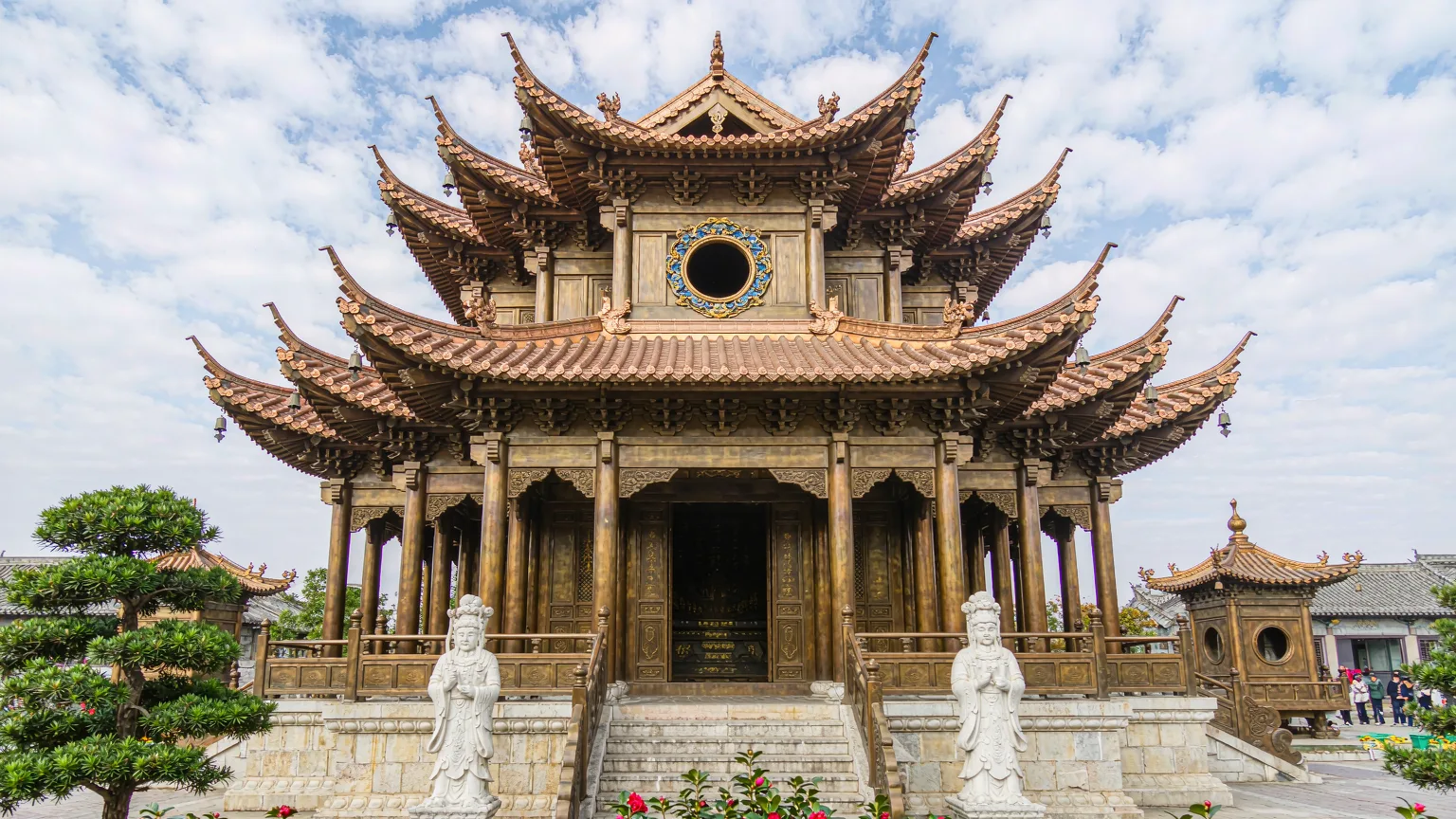 Bronze Golden Temple hall with copper roof and camellias in Kunming