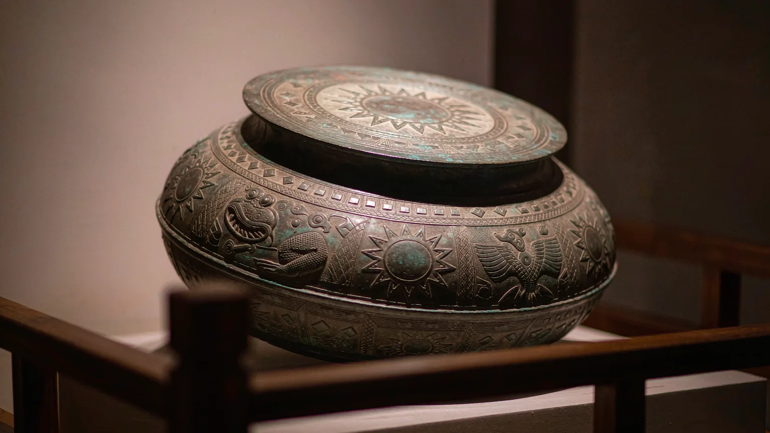Ancient bronze drum with frog and sun motifs in close-up