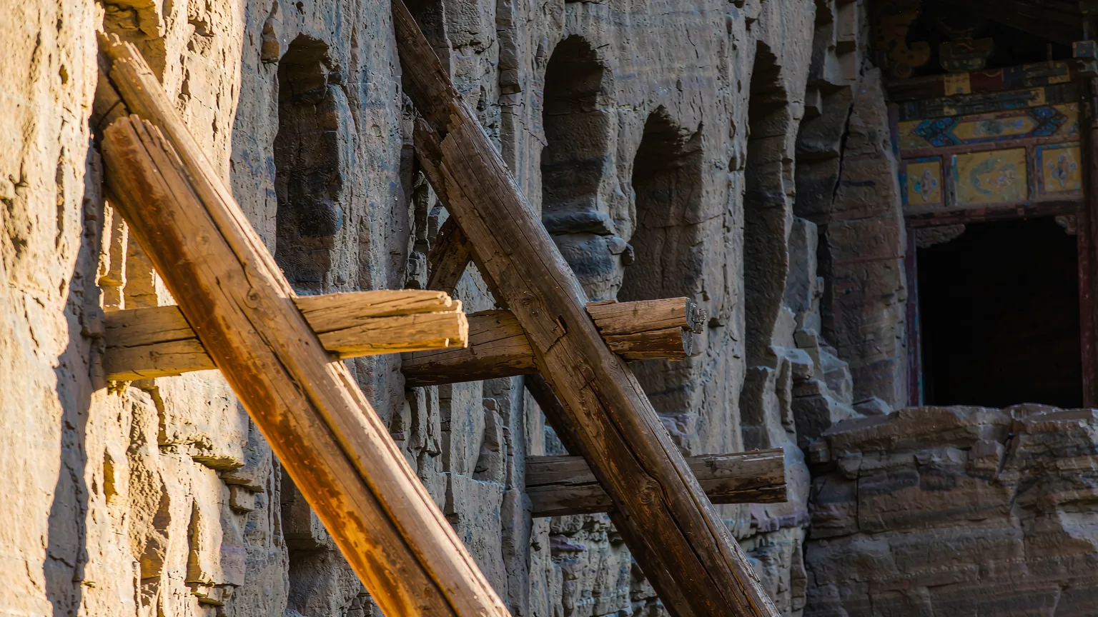 Close-up of ancient wooden support beams embedded in rock beneath Hanging Temple
