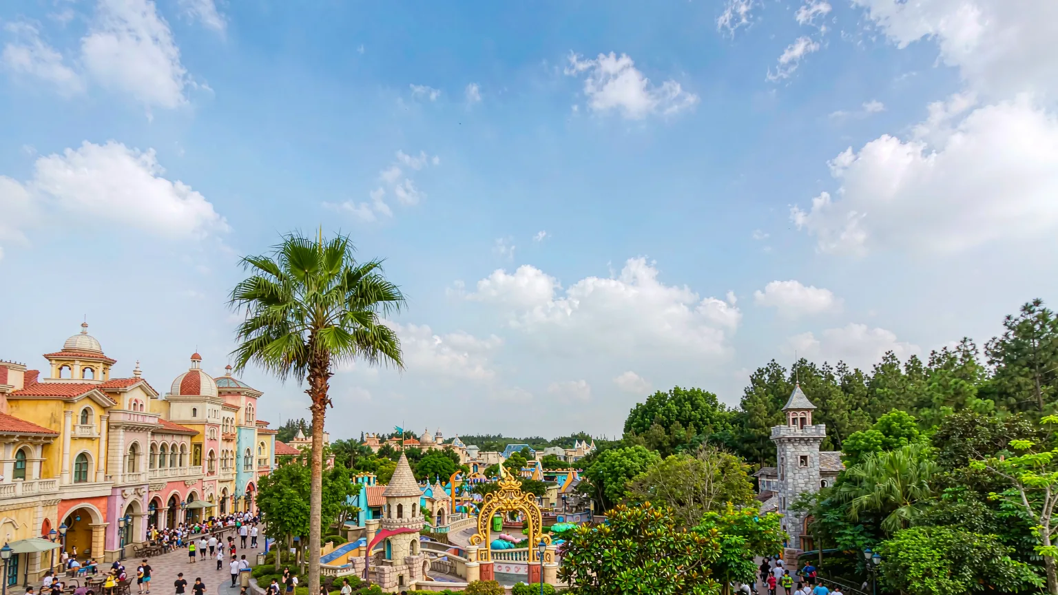 Colorful themed zones of Happy Valley Shenzhen with visitors exploring