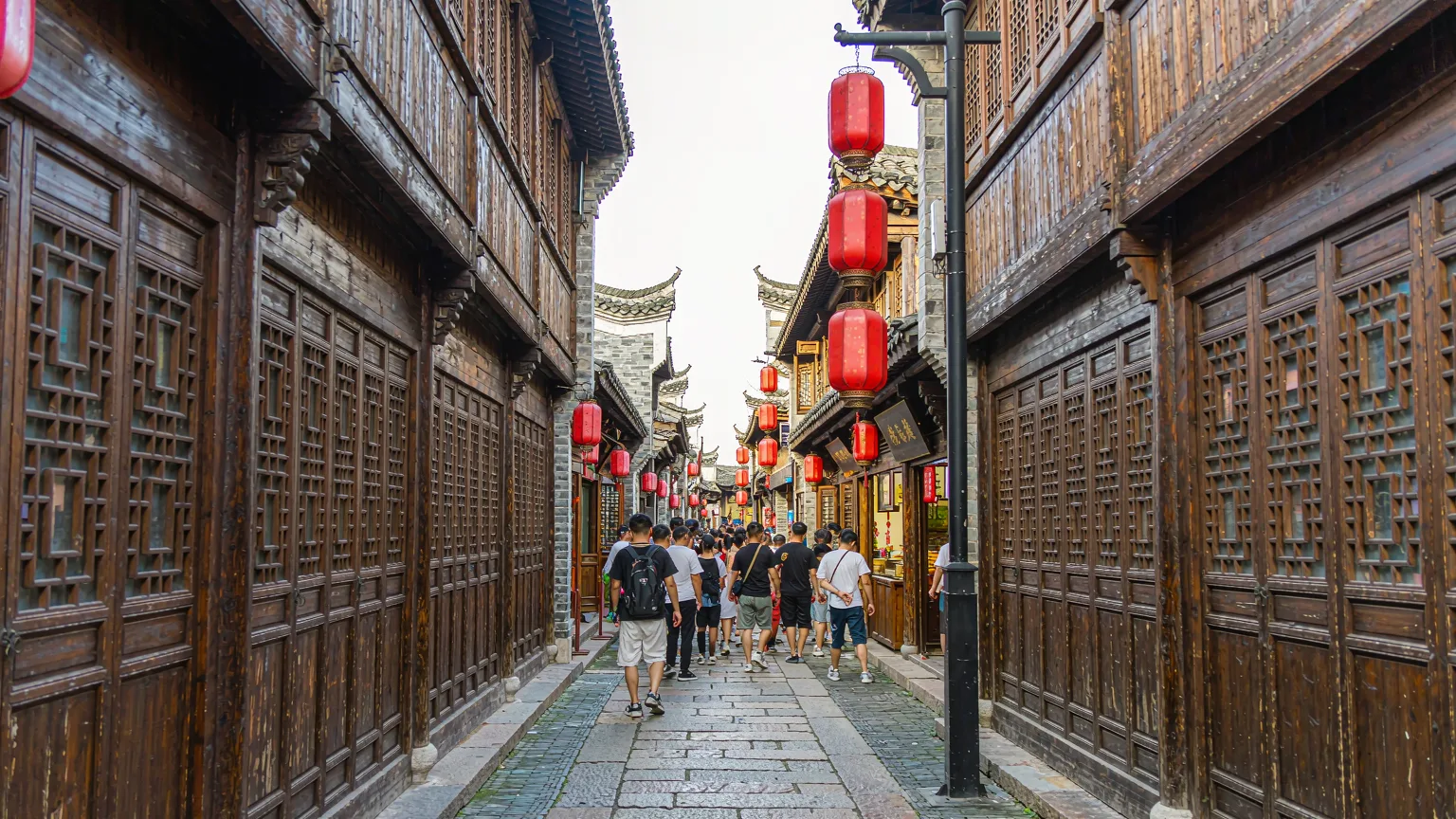 Historic wooden shopfronts and stone-paved lane on Hefang Street
