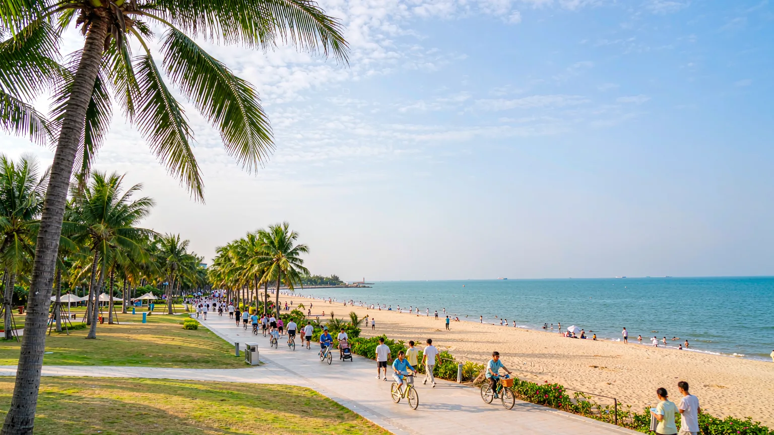 Holiday Beach promenade with cyclists and palm trees