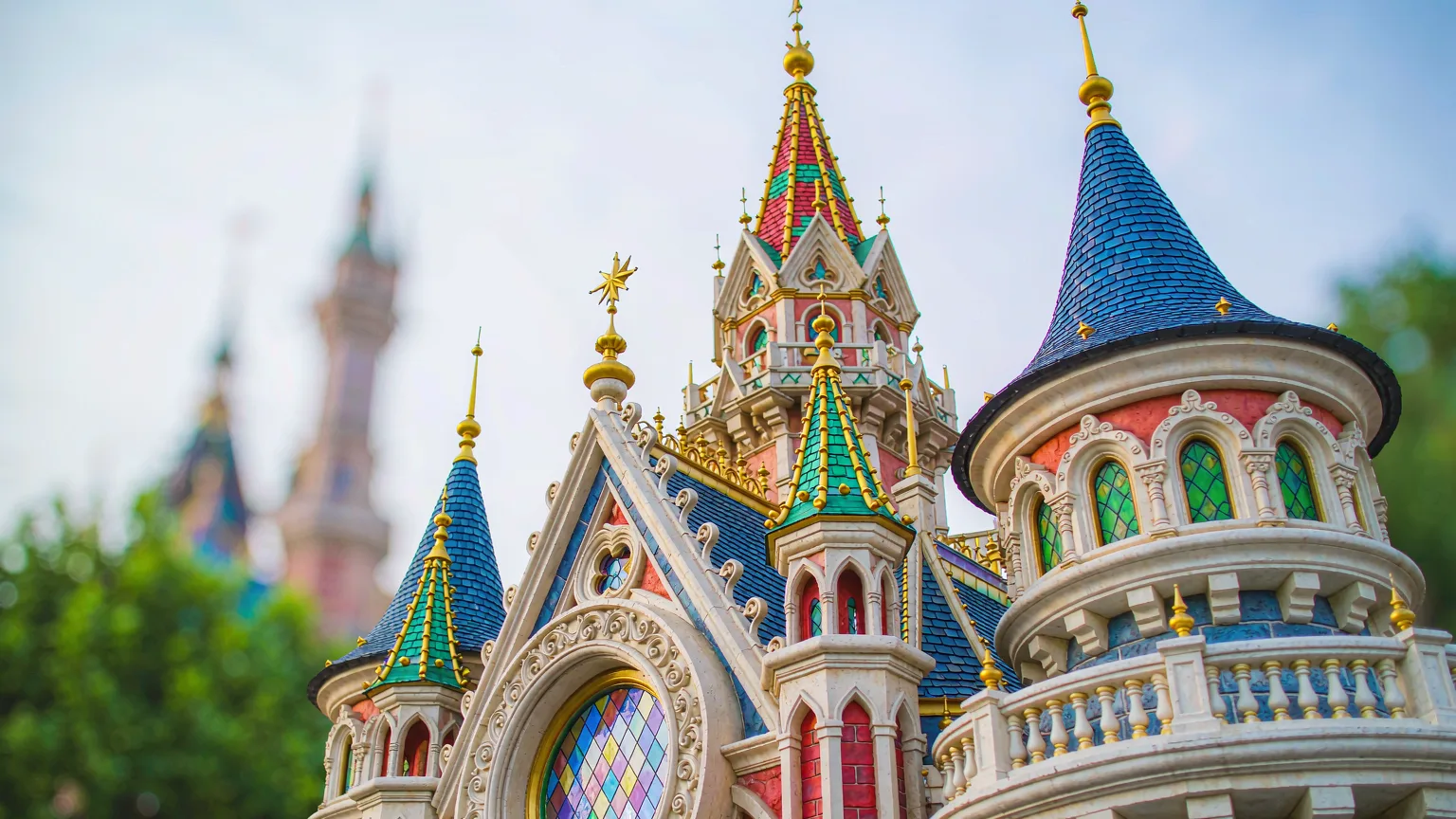 Close-up of Sleeping Beauty Castle's colorful turrets and golden details