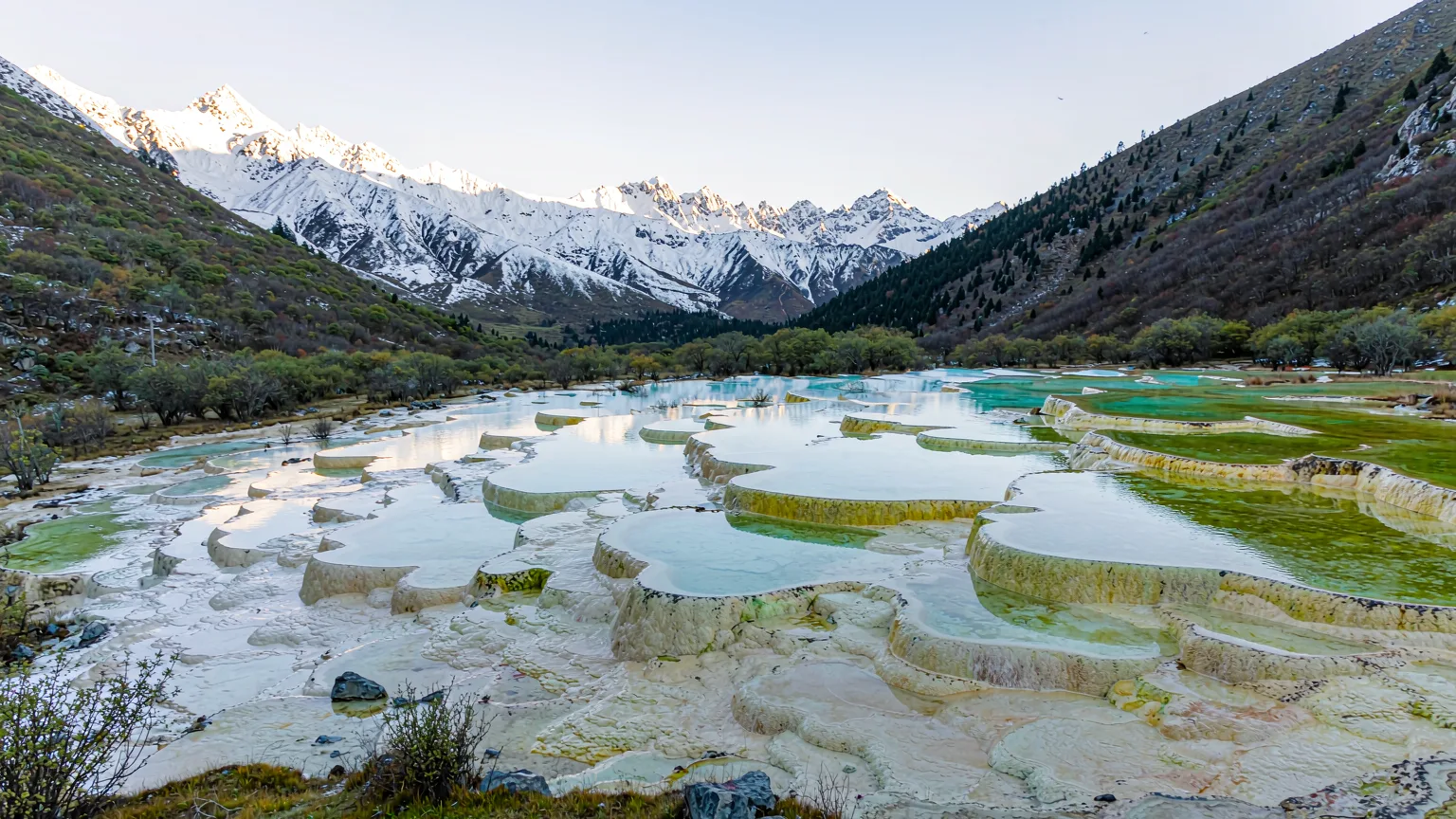 Five-Colour Pond's terraced turquoise pools on Huanglong's high-altitude plateau