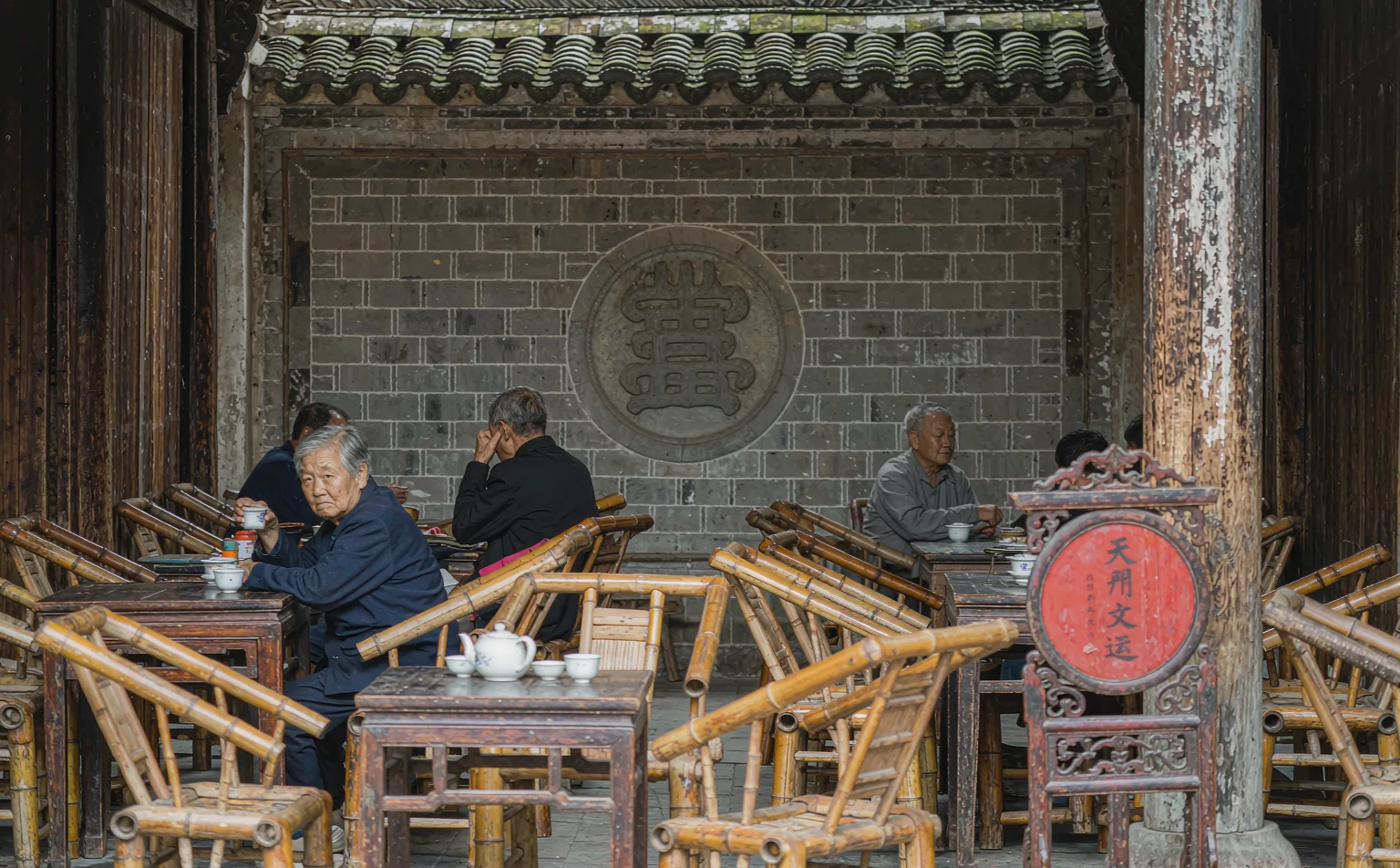 Old teahouse interior with bamboo chairs in Huanglongxi Ancient Town