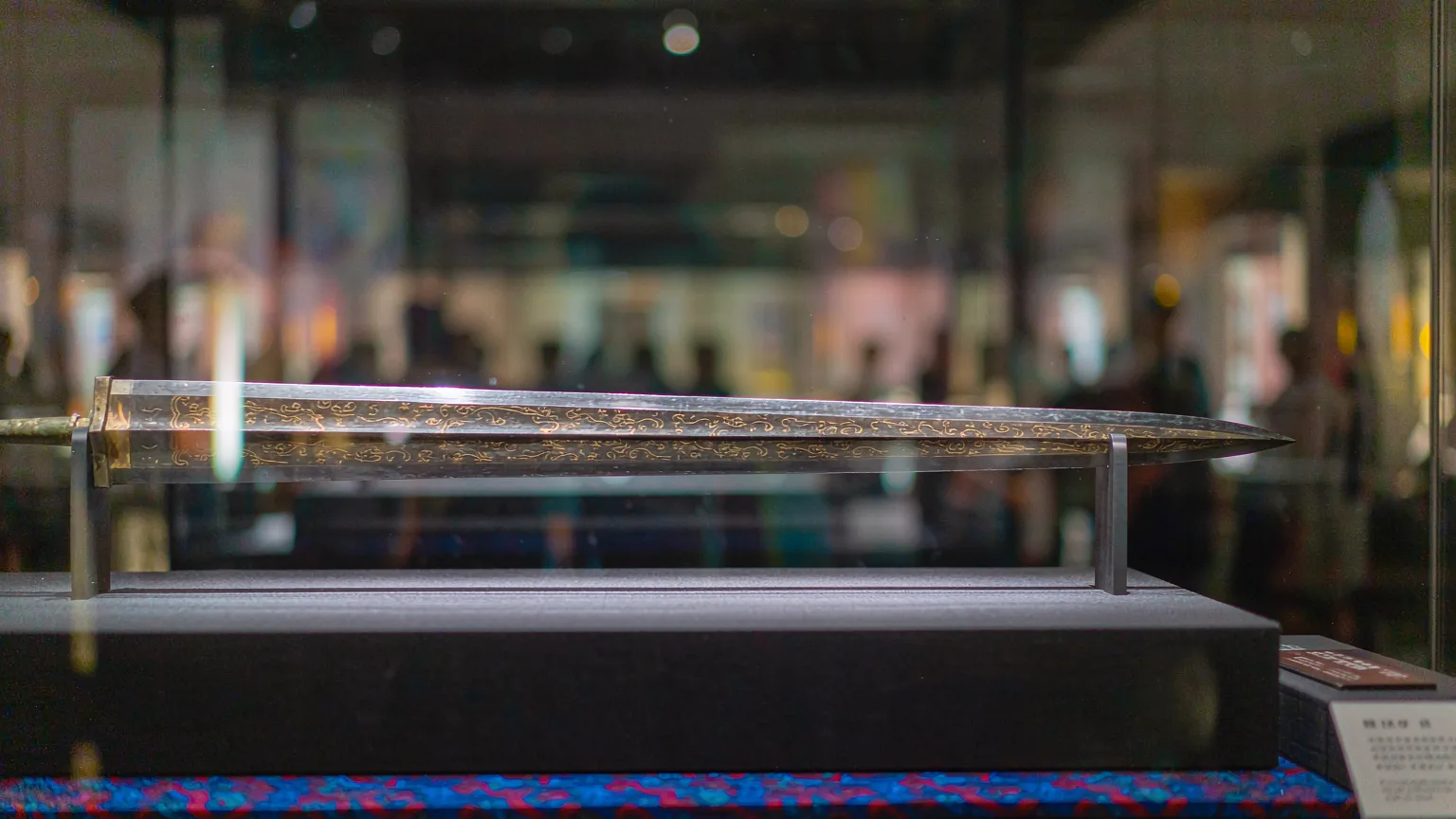 Close-up of Sword of Goujian with gold-inlaid patterns in display case