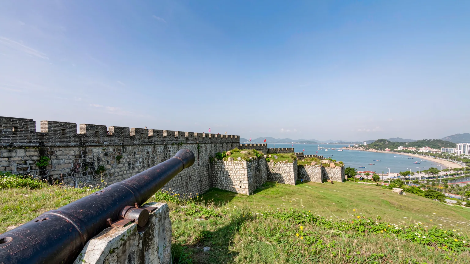 Hulishan Fortress stone walls and Krupp gun with Xiamen coastline