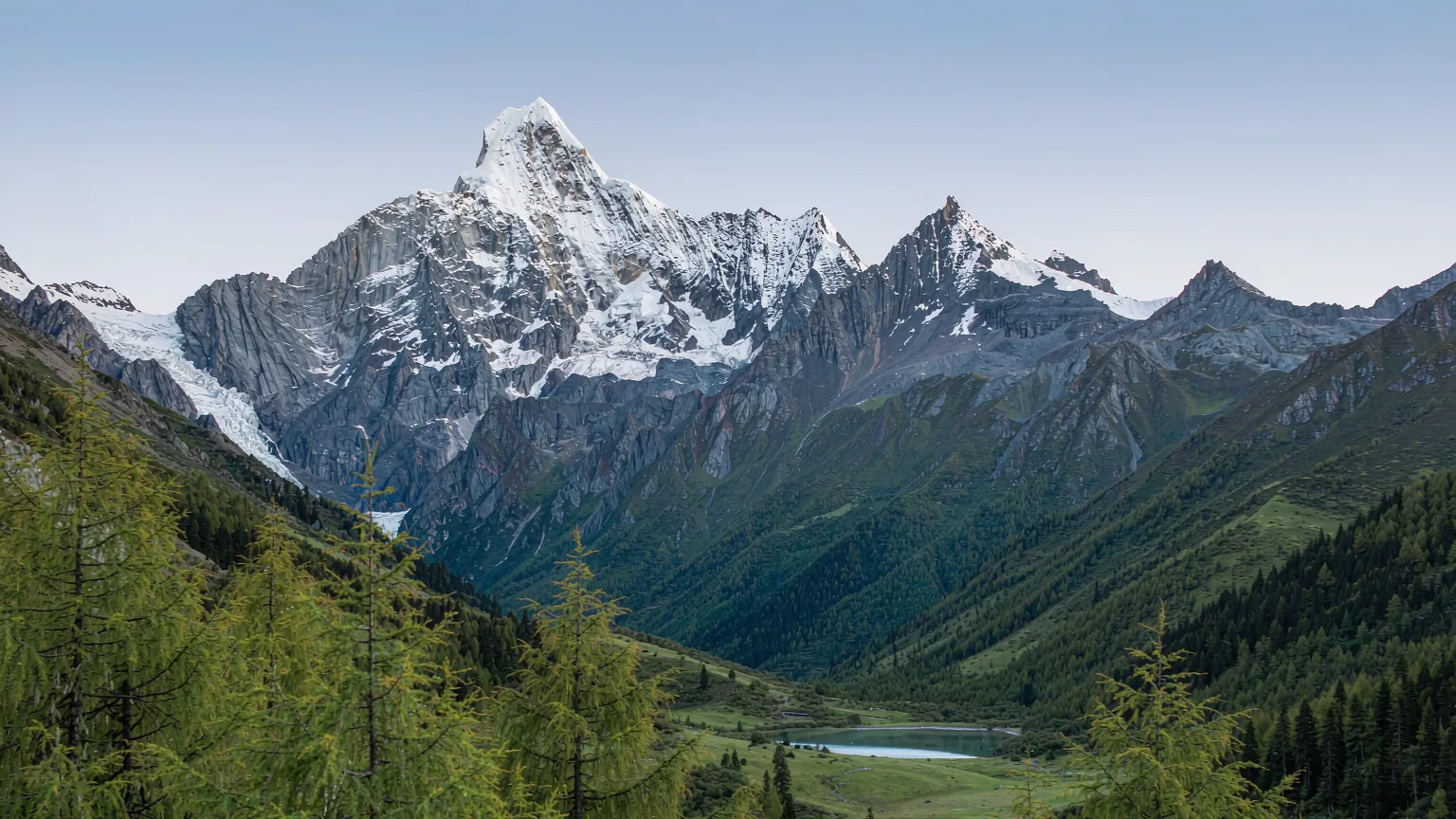Thirteen peaks of Jade Dragon Snow Mountain with glacier and green valley below