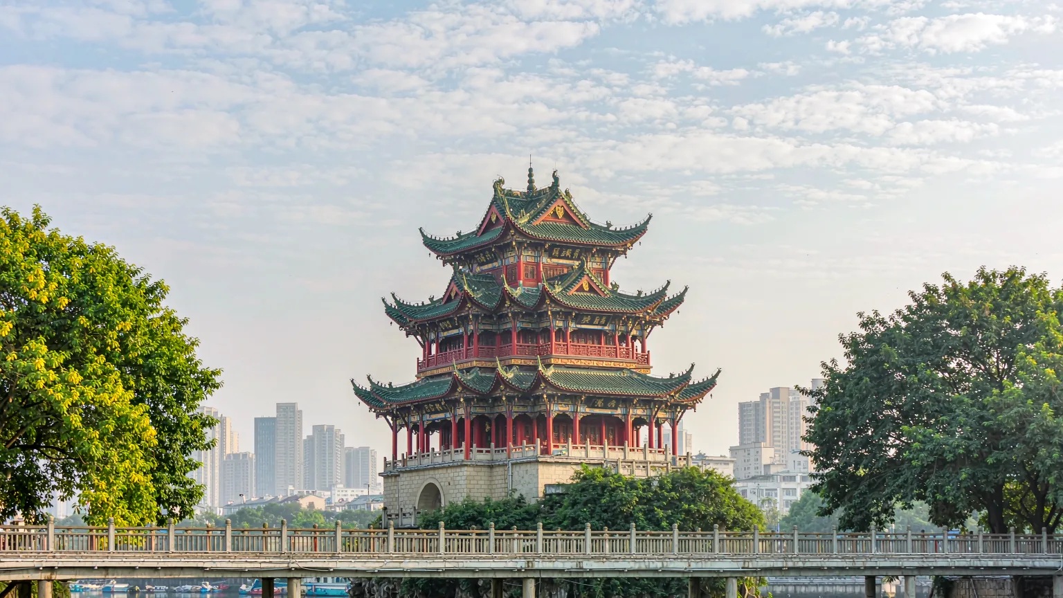 Three-tiered Jiaxiu Tower pavilion on Aoji Rock with stone bridge in Guiyang