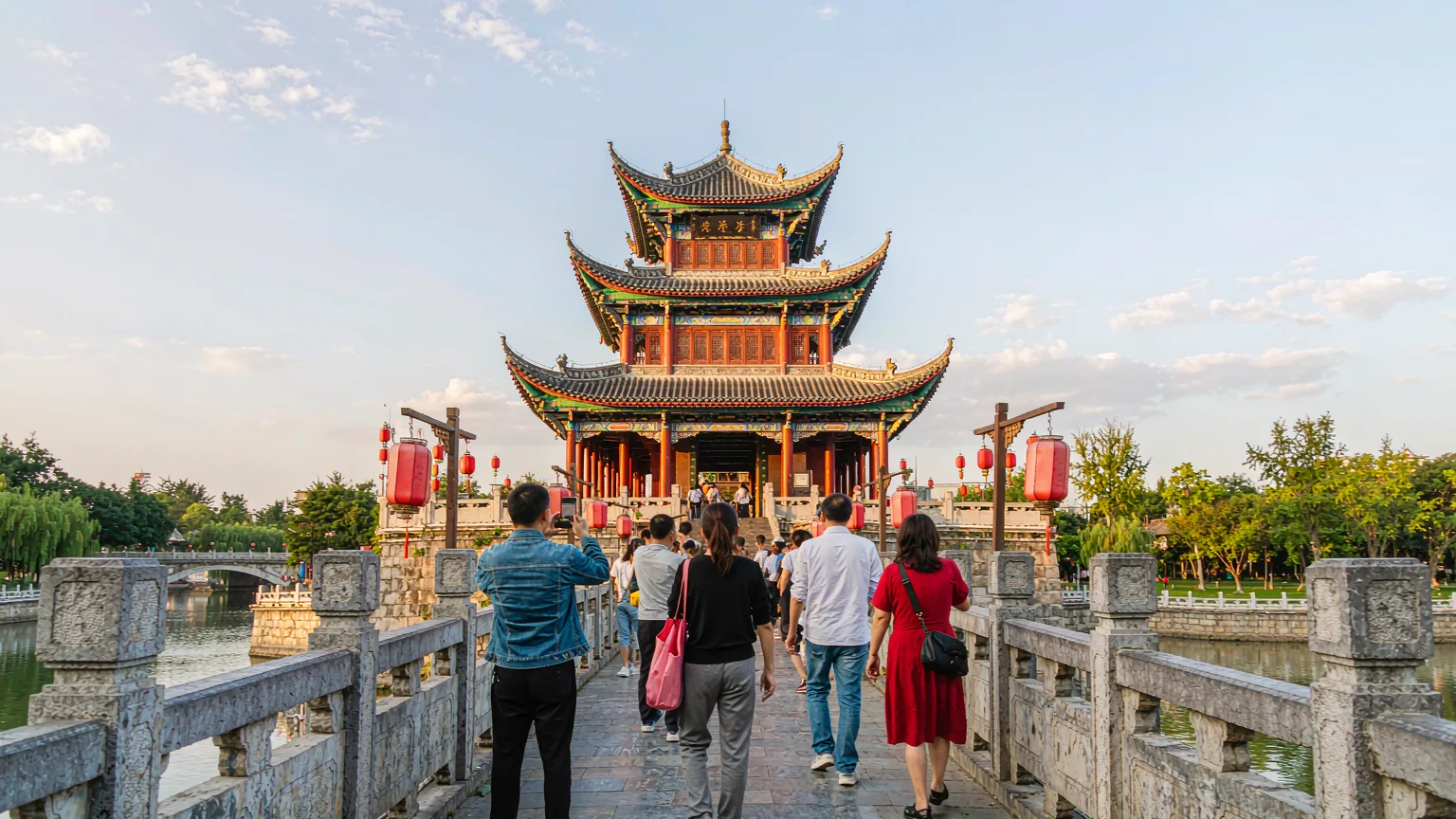 Travelers crossing Fuyu Bridge toward Jiaxiu Tower entrance in Guiyang