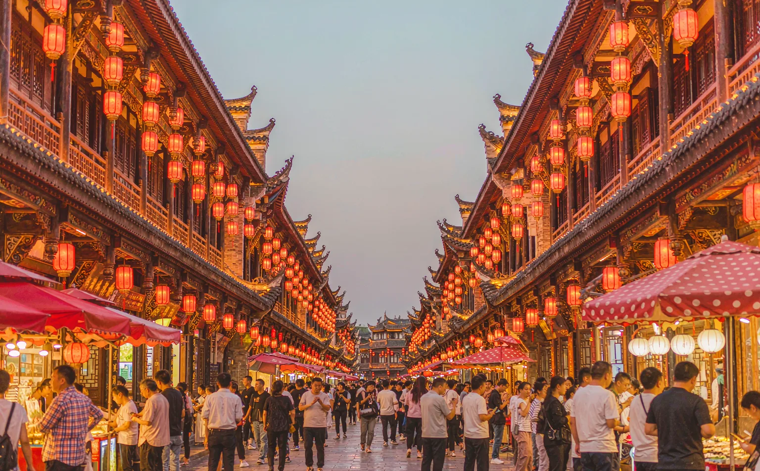 Red lanterns over Qing dynasty style buildings on Jinli Ancient Street at dusk