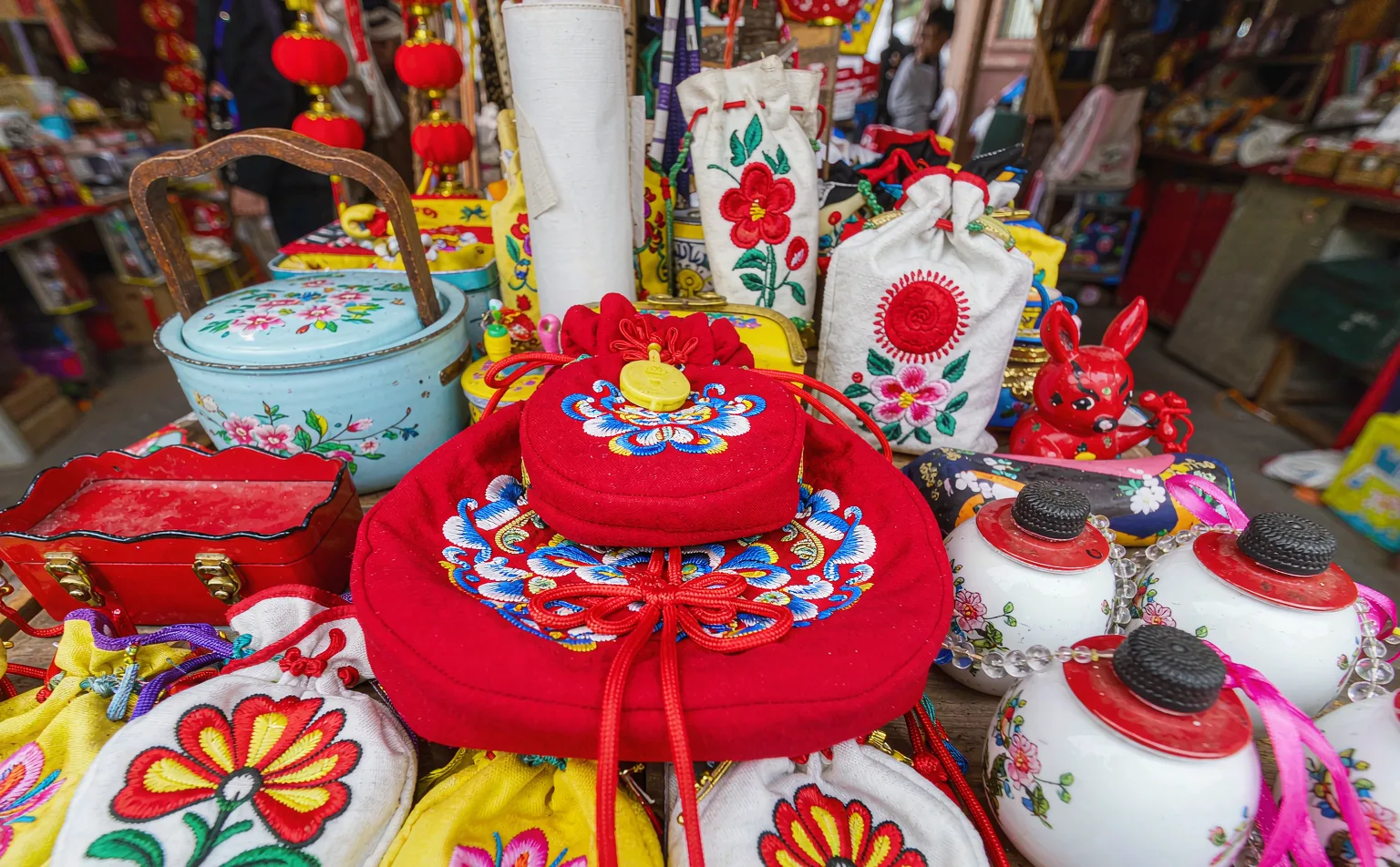 Traditional Sichuan folk crafts displayed at a stall in Jinli