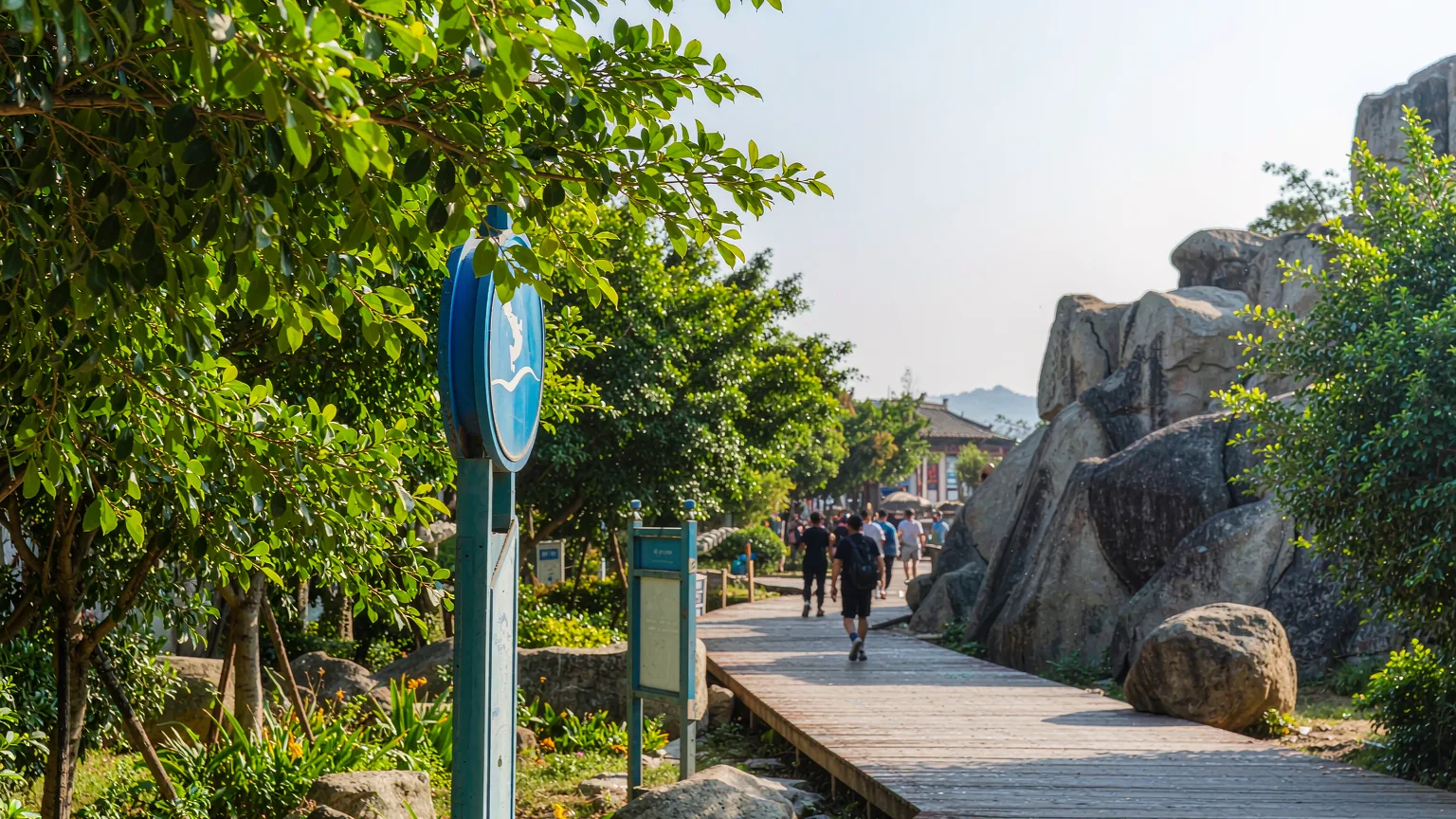 Tourists on a boardwalk approaching Jinshitan's rock formations