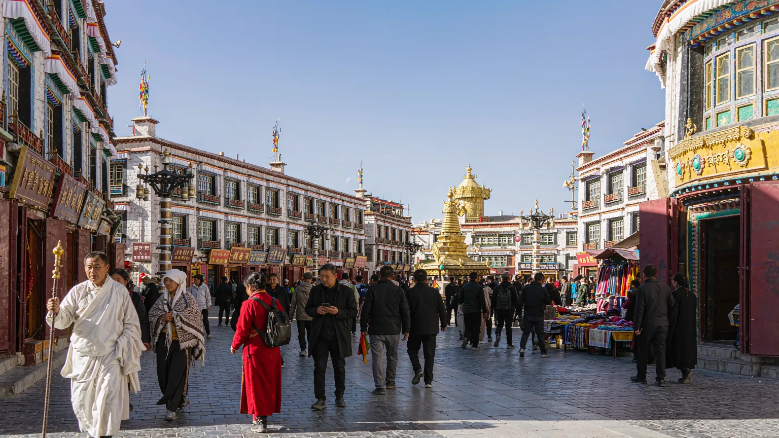 Pilgrims walking along Barkhor Street toward Jokhang Temple entrance