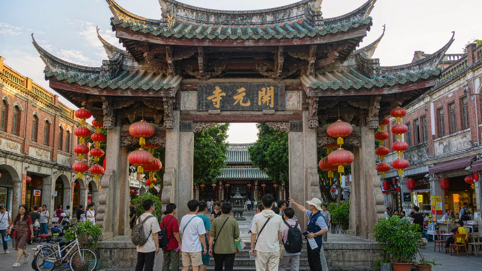 Visitors entering Kaiyuan Temple's main gate on West Street with a guide