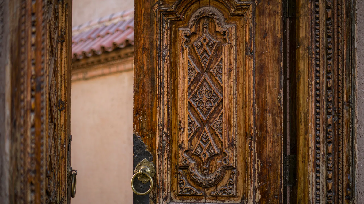 Close-up of a hand-carved wooden door with Uyghur patterns in Kashgar