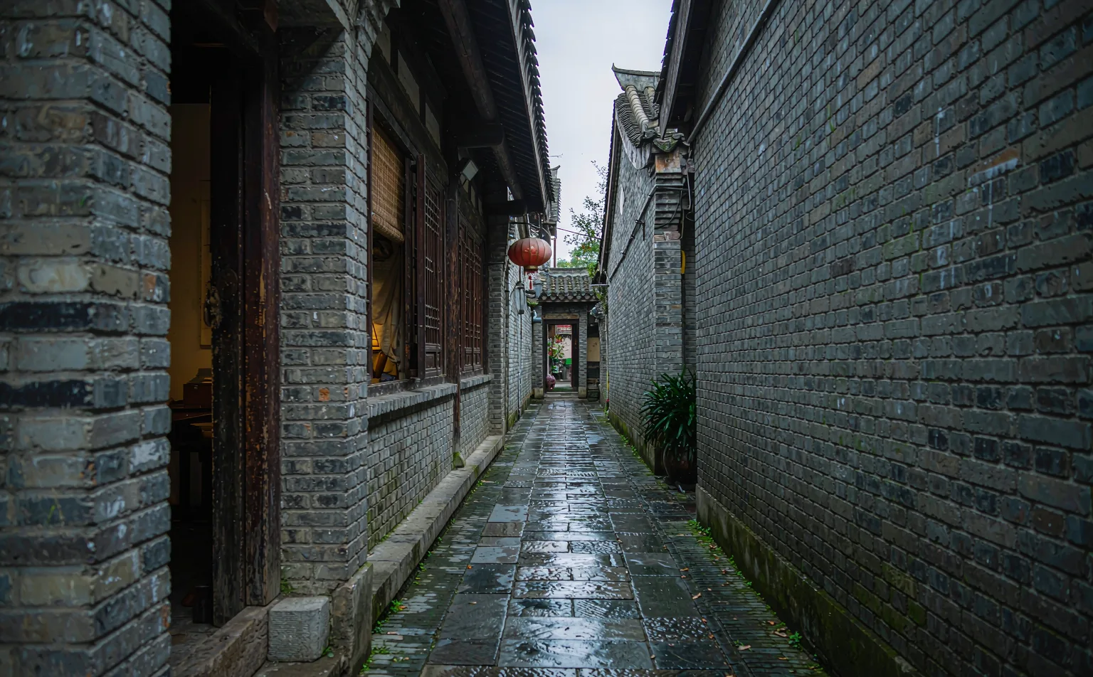 Old grey brick walls in the narrow alley of Kuanzhai Alleys
