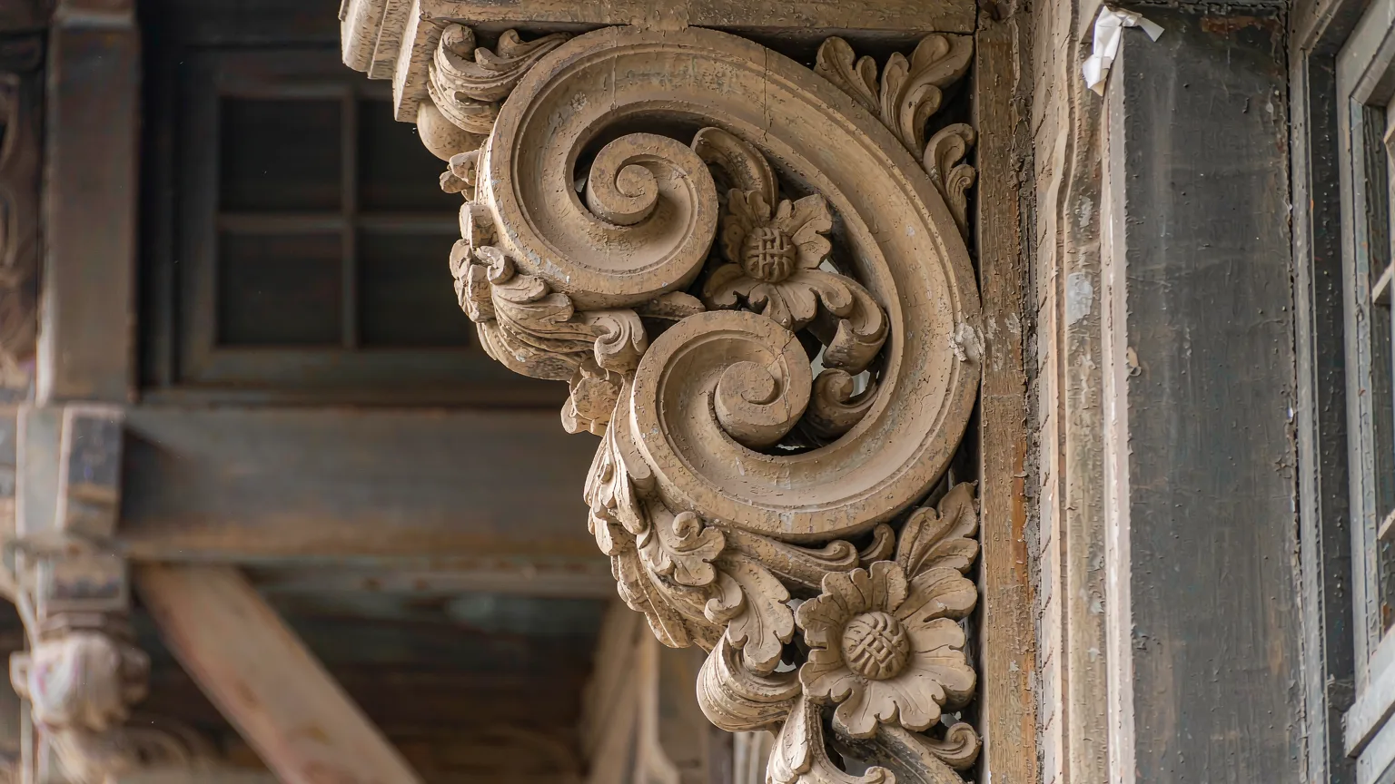 Intricate carved stone detail with floral motifs on a Chinese Baroque building in Lao Daowai