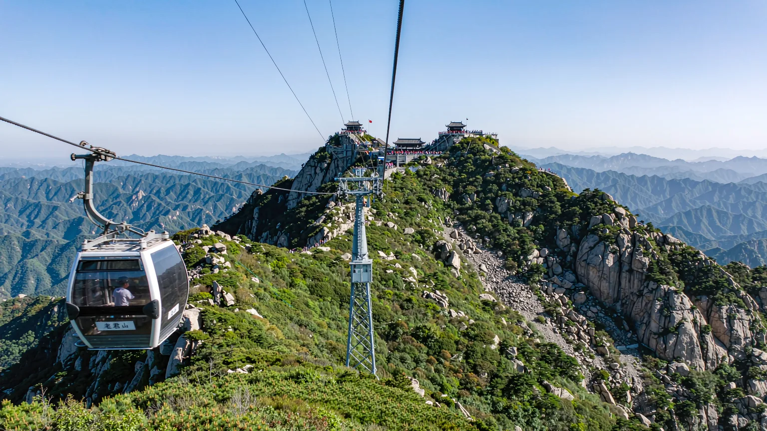 Cable car ascending Laojun Mountain with panoramic views of peaks