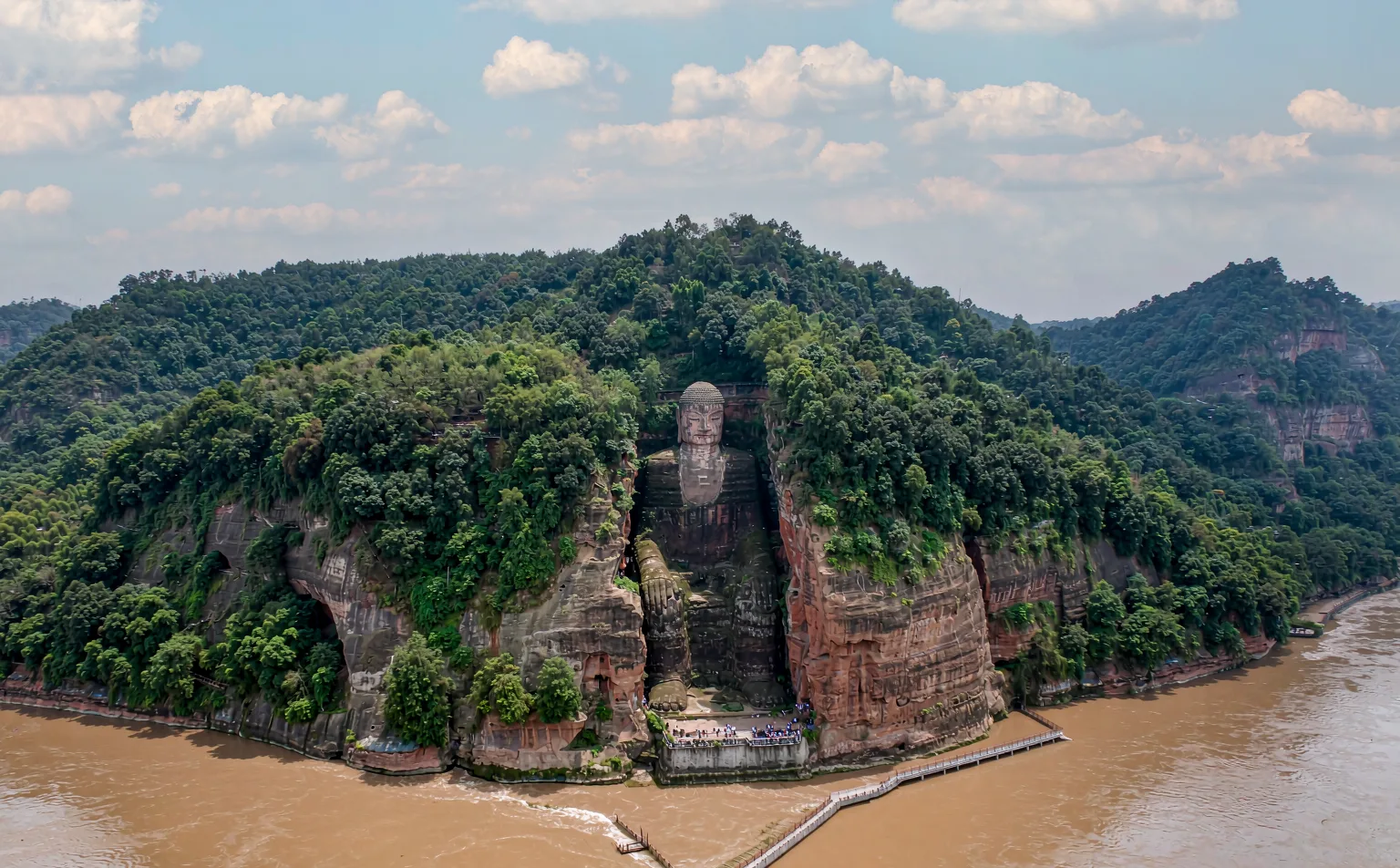 The Leshan Giant Buddha carved into the cliff, seen from the river